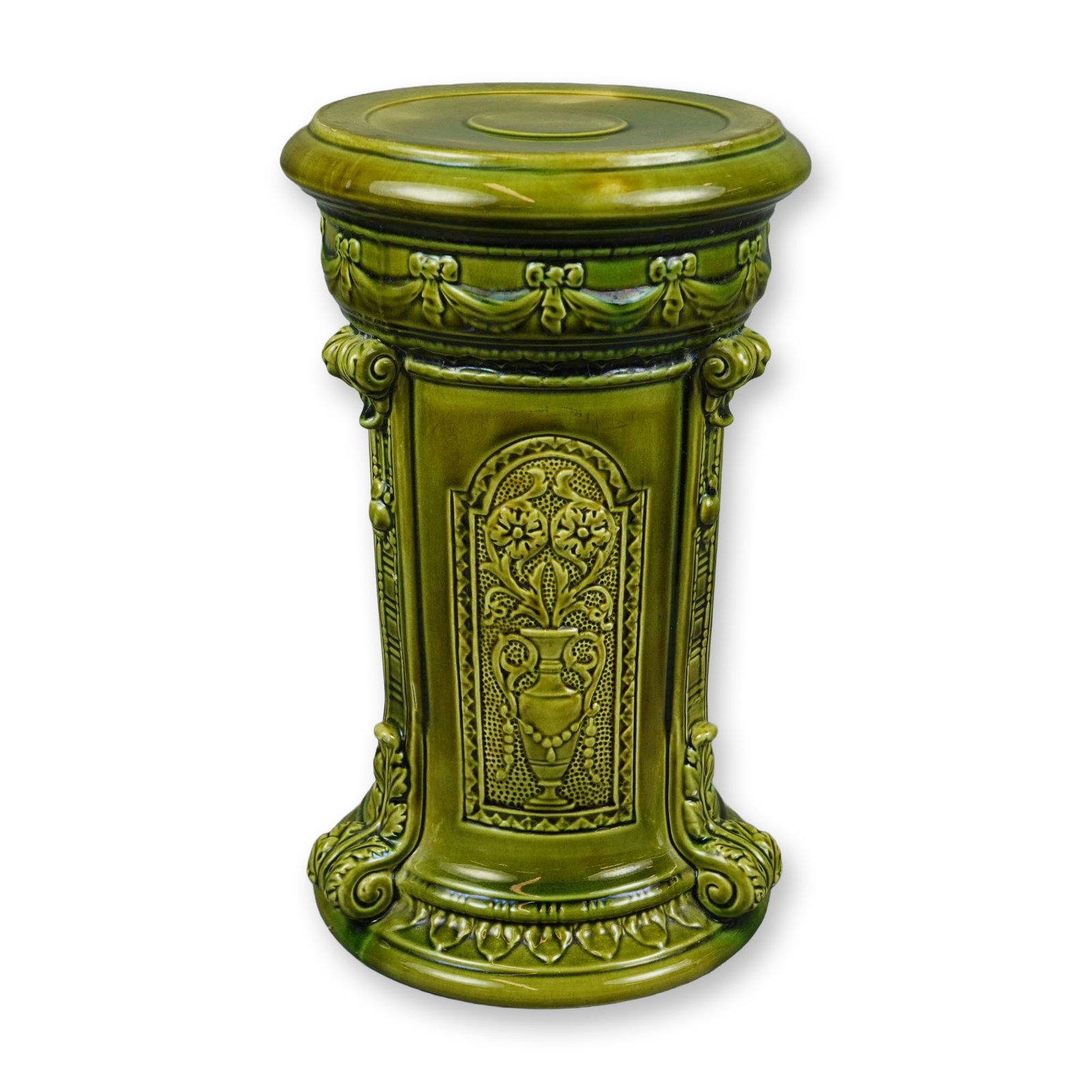 Wedgwood Majolica Green Glaze Ceramic Pedestal Plinth: A Wedgwood majolica earthenware pedestal plinth, designed as a stand for a large jardiniere or planter. The piece is of cylindrical form with a flared, circular top and base. It features Neo-Renaissan