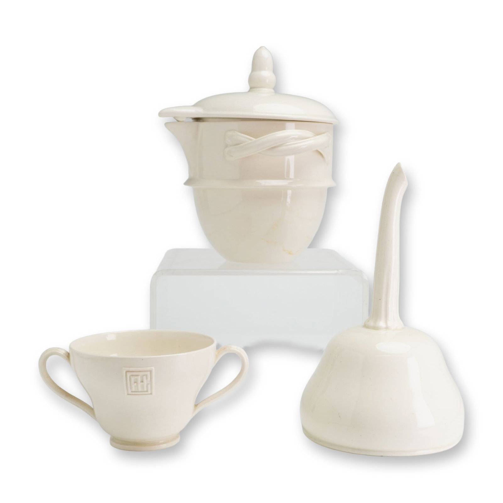 Three Wedgwood English Creamware Utilitarian Vessels: English, late 18th to early 19th century. A group of three creamware vessels comprising a veilleuse, a jelly funnel strainer, and a double-handled cup. The lidded veilleuse or milk warmer features a r