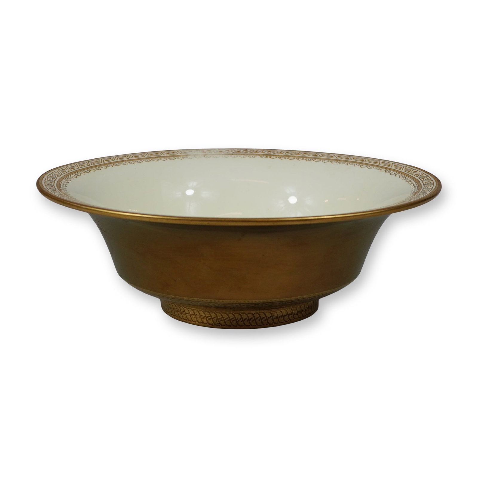Wedgwood Gold Gilt and Ivory Glazed Bowl: A Wedgwood circular bowl of flared form raised on a short footed base. The exterior and the foot are finished with a solid matte gold gilding. The interior features an ivory-toned glaze decorated with