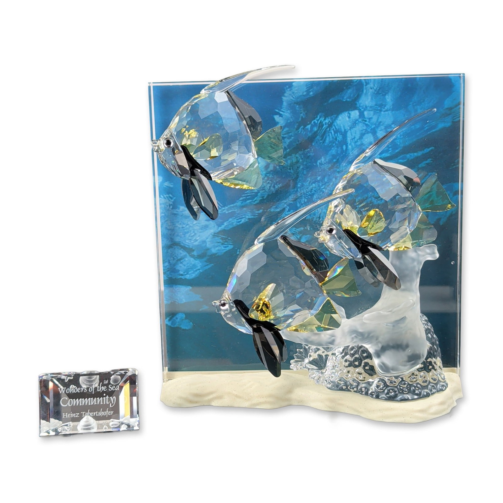 2pc Swarovski Wonders of the Sea Community Crystal Sculpture and Title Plaque: Swarovski Wonders of the Sea Community crystal sculpture, designed by Heinz Tabertshofer as the 2007 Annual Edition. The piece features three faceted crystal Bannerman angelfish with yellow and black 