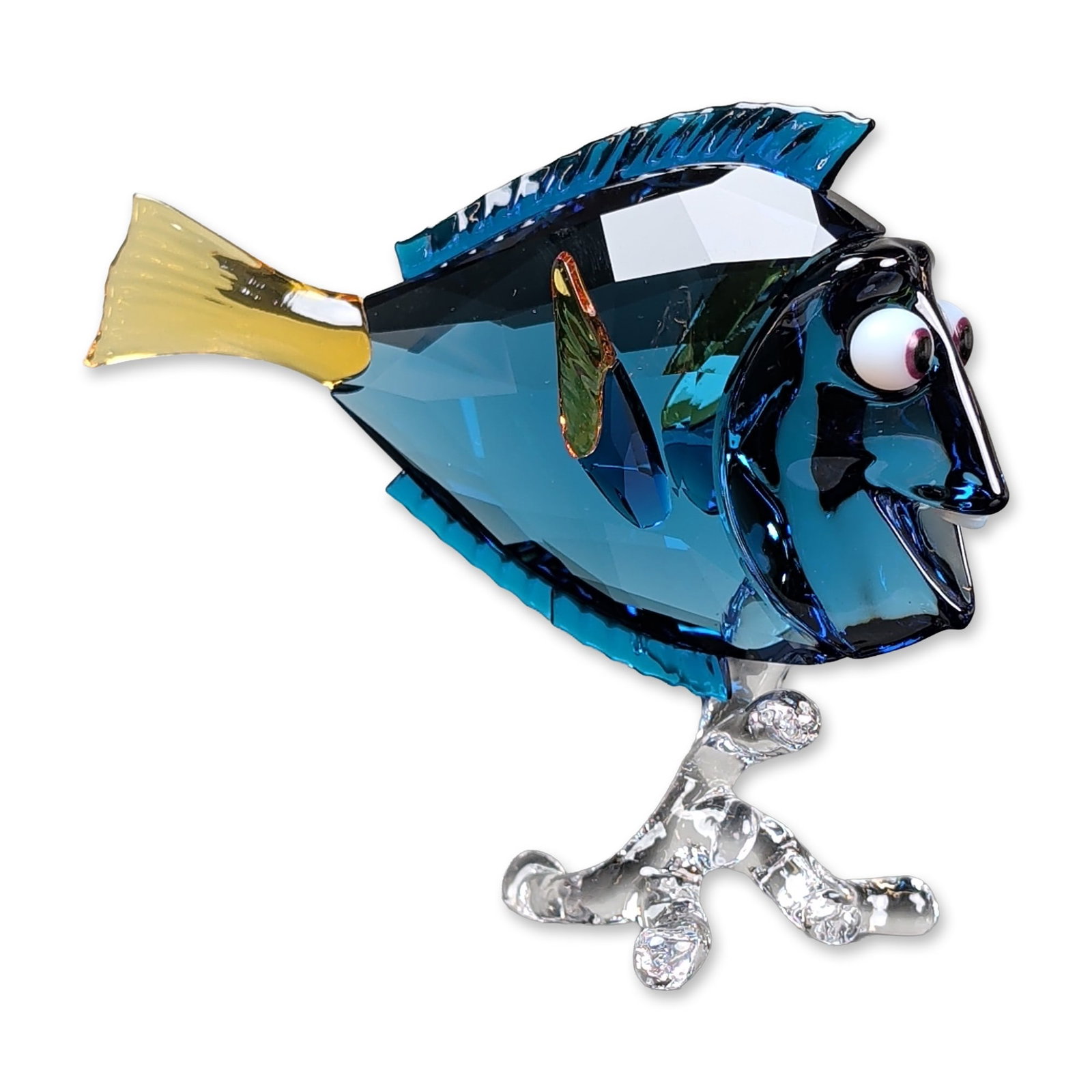 Swarovski Crystal Disney Finding Nemo Figurine, Dory: Swarovski crystal figurine depicting Dory from the Disney Pixar Finding Nemo collection. The piece is composed of faceted blue and turquoise crystal with an amber-toned tail and fin, attached to a cle