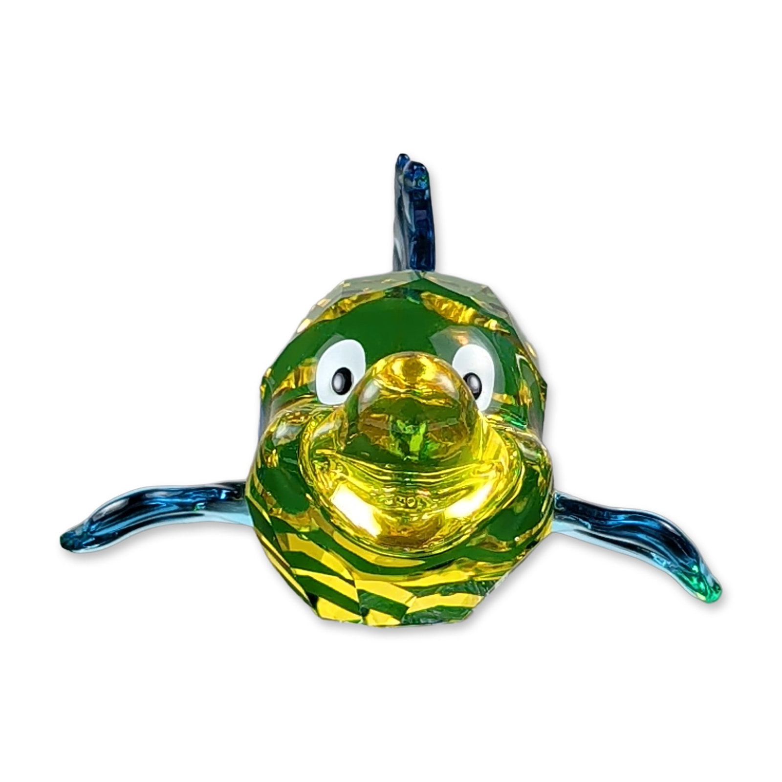 Swarovski Disney Crystal Flounder Figurine: Swarovski faceted lead crystal figurine depicting the character Flounder from Disney's The Little Mermaid. The figure features a yellow and blue striped faceted body, translucent blue fins, and a clea