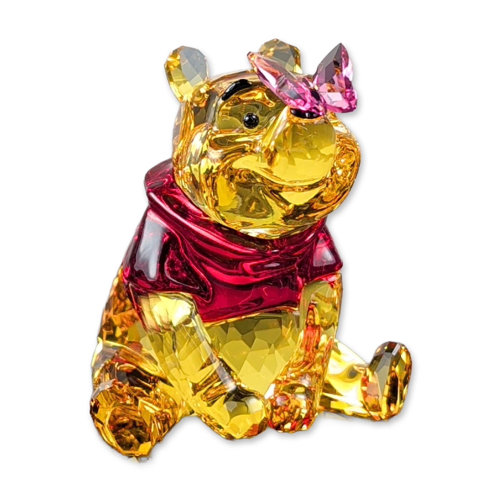Swarovski Crystal Disney Winnie the Pooh with Butterfly Figurine: Swarovski Disney collection faceted lead crystal figurine, Winnie the Pooh with Butterfly, model 82928. The figure is composed of golden yellow crystal for the body and head, a red crystal shirt, and 