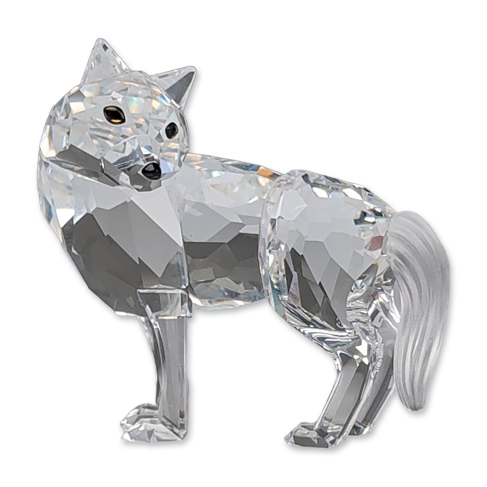 Swarovski Silver Crystal Fairy Tales Wolf Figurine: Swarovski Wolf from the Silver Crystal collection Fairy Tales constructed from faceted clear lead crystal with a frosted crystal tail and black bead accents for the eyes and nose. The figurine is depi