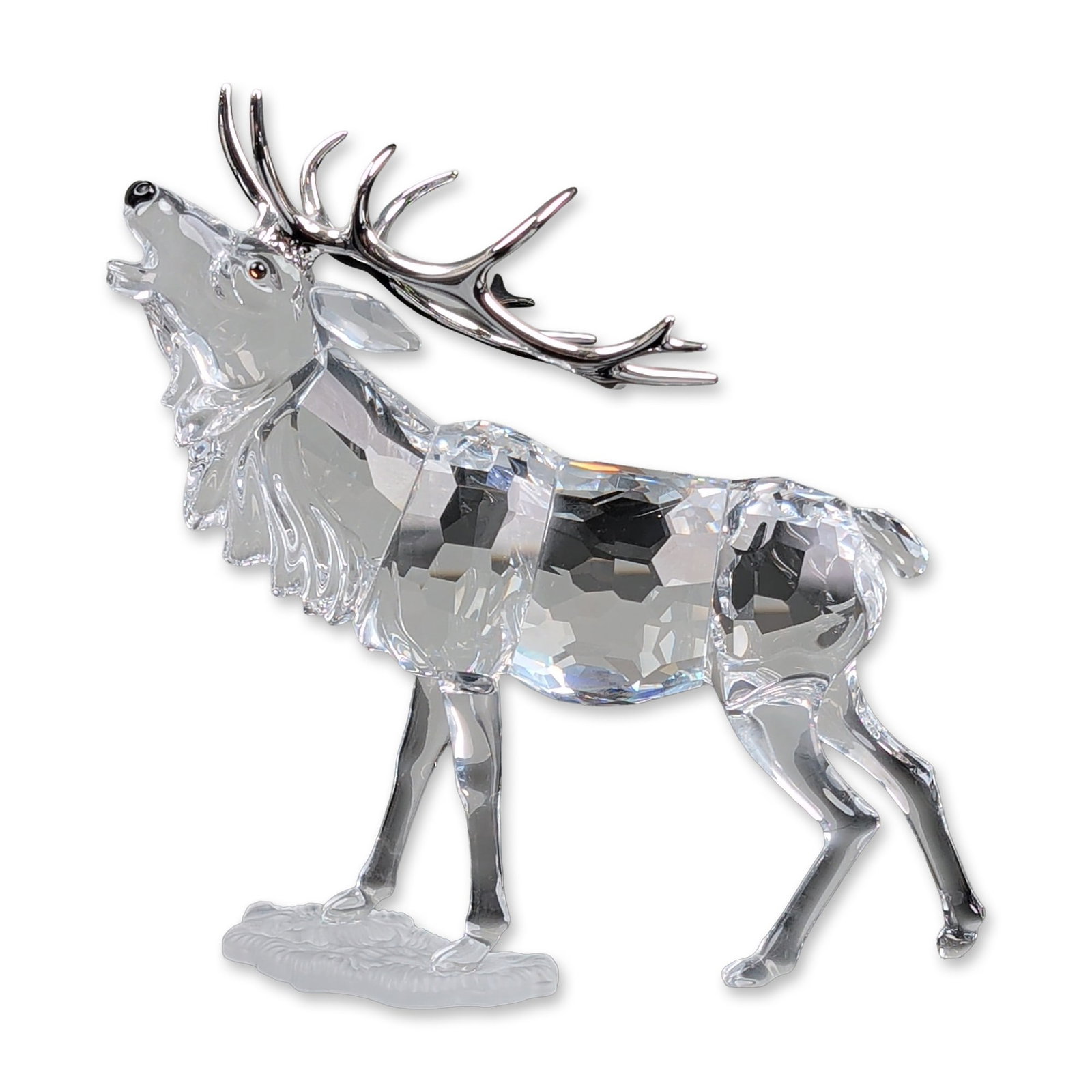Swarovski Crystal Figurine, Stag: Swarovski crystal stag figurine featuring a multi-faceted clear lead crystal body and head. The piece is accented with polished rhodium-plated metal antlers and stands upon a frosted glass oval base w