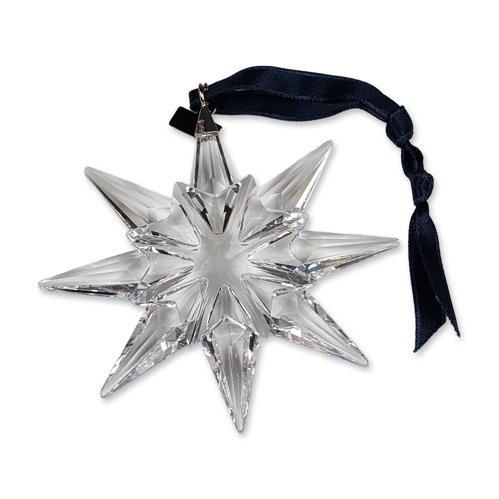 Swarovski 2009 Annual Edition Crystal Star Ornament: Swarovski 2009 Annual Edition star Christmas ornament in faceted clear lead crystal, featuring a three-dimensional starburst design with multi-faceted points. It includes a silver-tone metal hang tag 