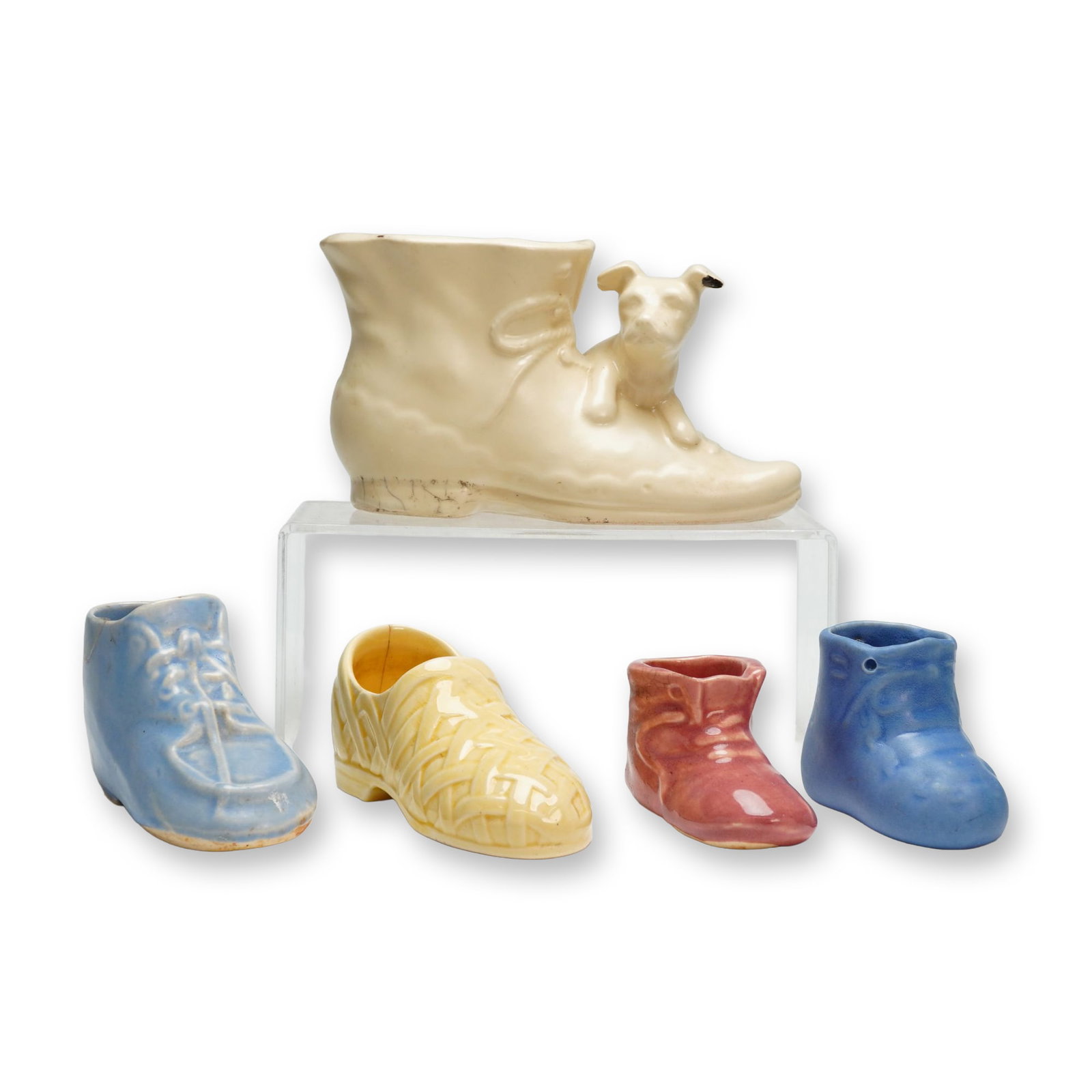 5pc American Pottery Ceramic Shoes: This collection of five mid-century American pottery glazed ceramic shoe-themed decorative vessels and ornaments includes a variety of forms and colors. The group features a large cream-colored plante