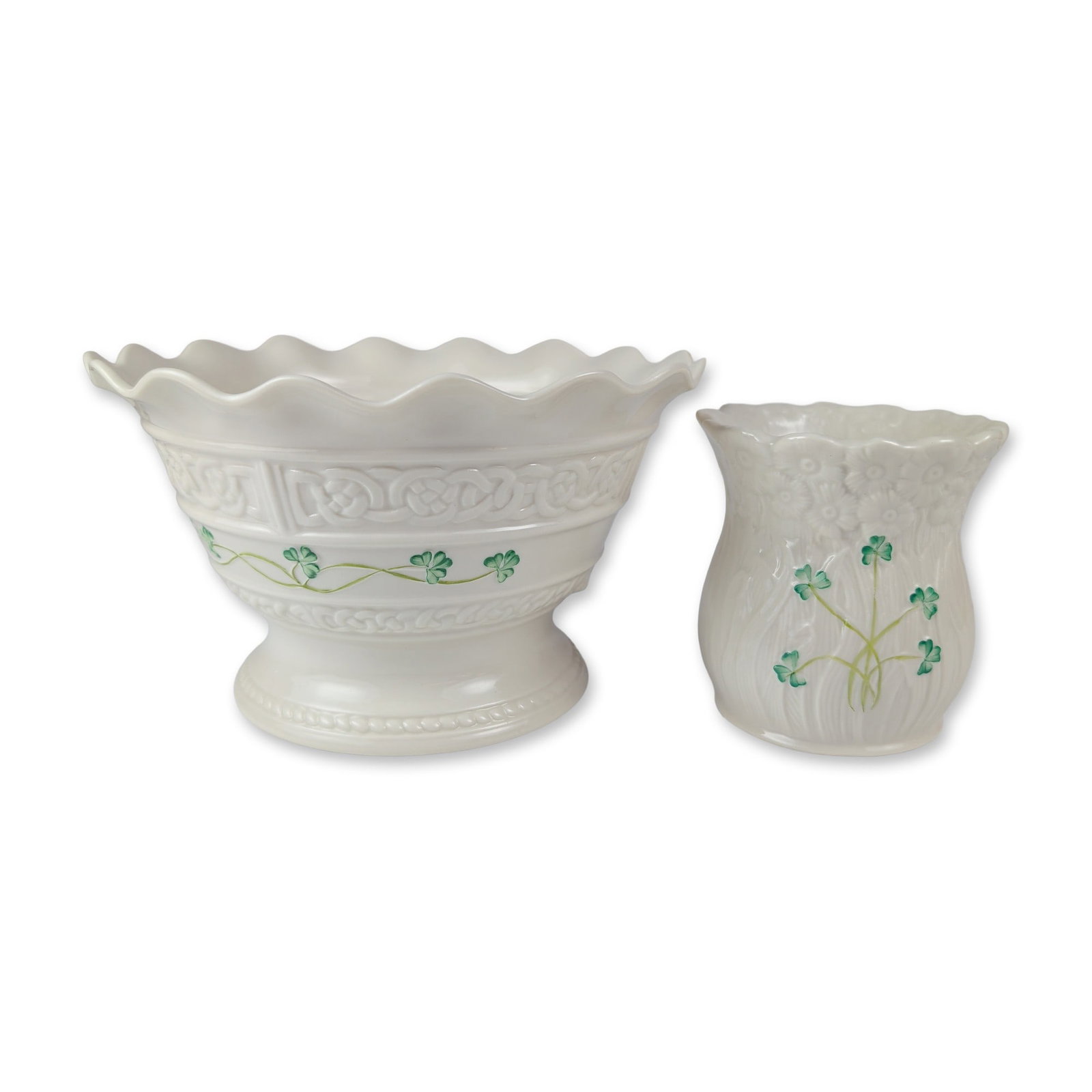 Two Belleek Irish Parian Porcelain Tablewares: Belleek, Ireland. Footed bowl and candle holder in parian porcelain, featuring hand-painted green shamrocks on a glazed surface. The Tara Collection bowl displays relief-molded Celtic knotwork bands a