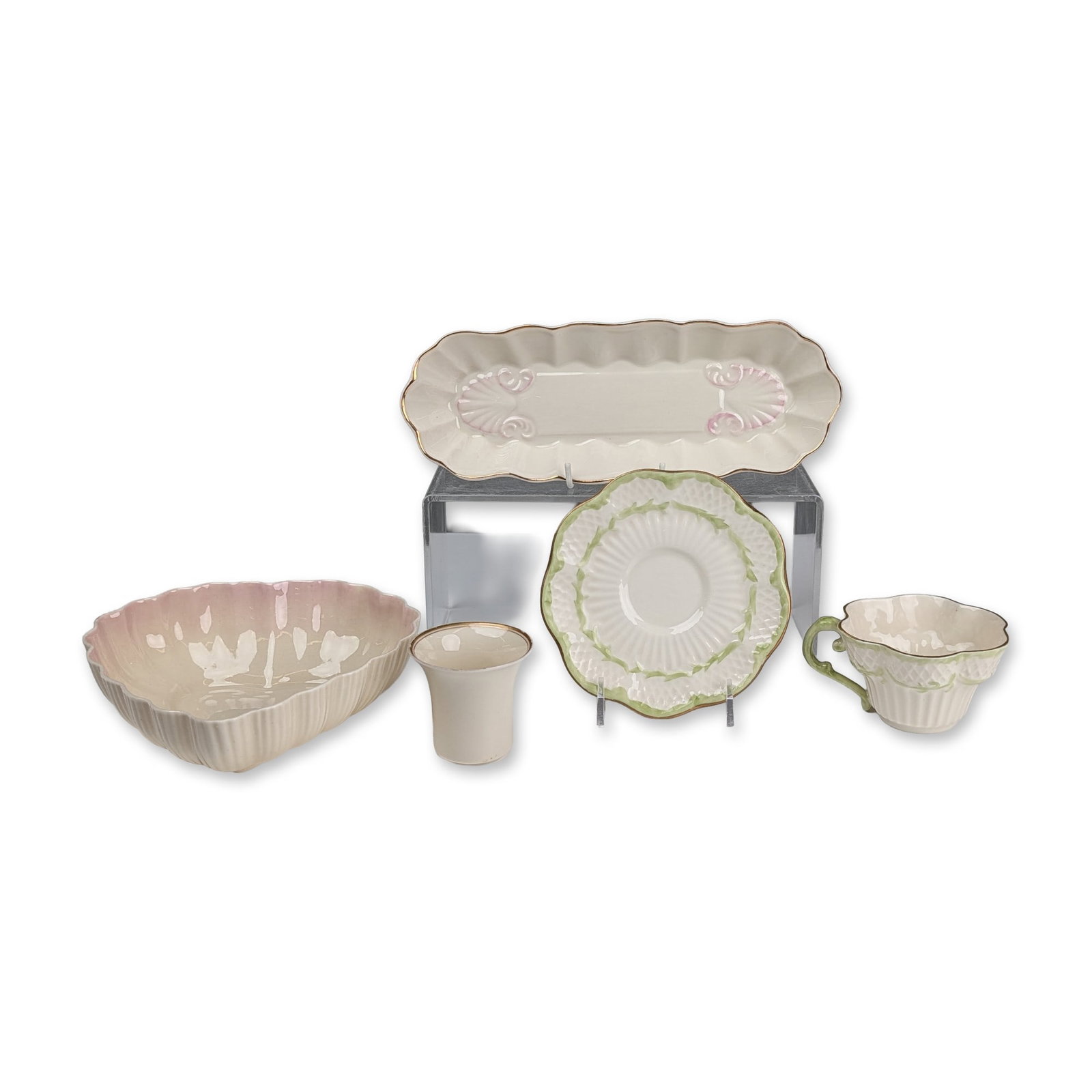 5pc Belleek Ireland Parian Porcelain Mixed Tableware: Belleek, Ireland. Tableware collection in parian porcelain, featuring a Millennium 2000 shell-handled tray, a shamrock basketweave teacup and saucer, a pink luster heart-shaped bowl, and a gold-rimmed