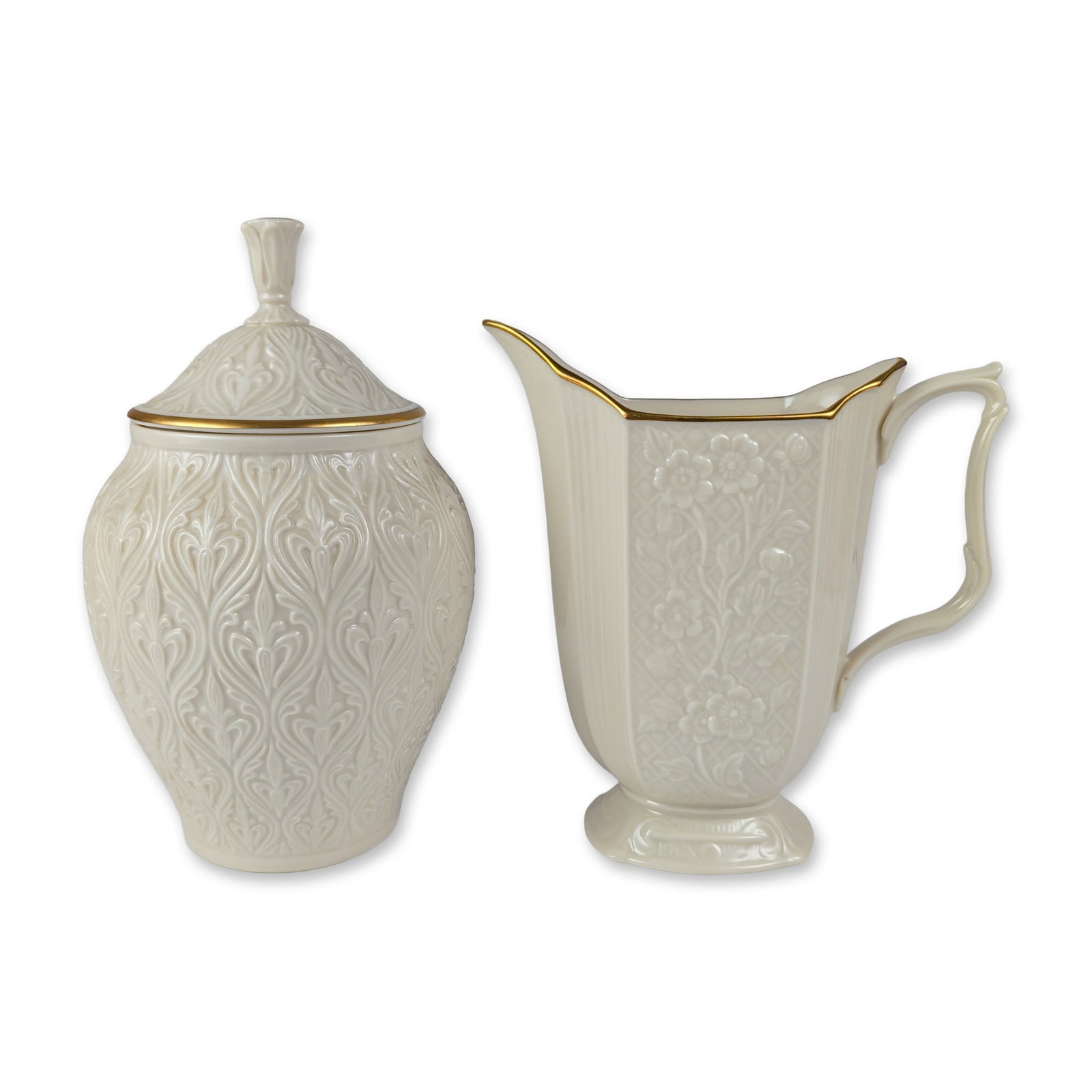 2pc Lenox Cream Colored Porcelain Tableware: Lenox, USA cream colored fine porcelain table items featuring embossed relief decoration and 24 karat gold trim. The lot includes one lidded candy jar in the Kismet pattern with all-over foliate scrol