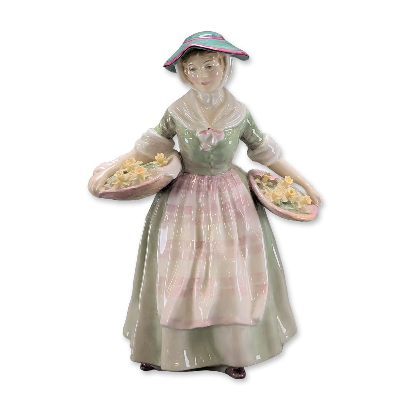 Royal Doulton Daffy-Down-Dilly Figurine: English Royal Doulton bone china figurine titled Daffy-Down-Dilly, model HN 1712. The figure is depicted in a green bodice and skirt with a pink-striped apron and matching bonnet, carrying two baskets
