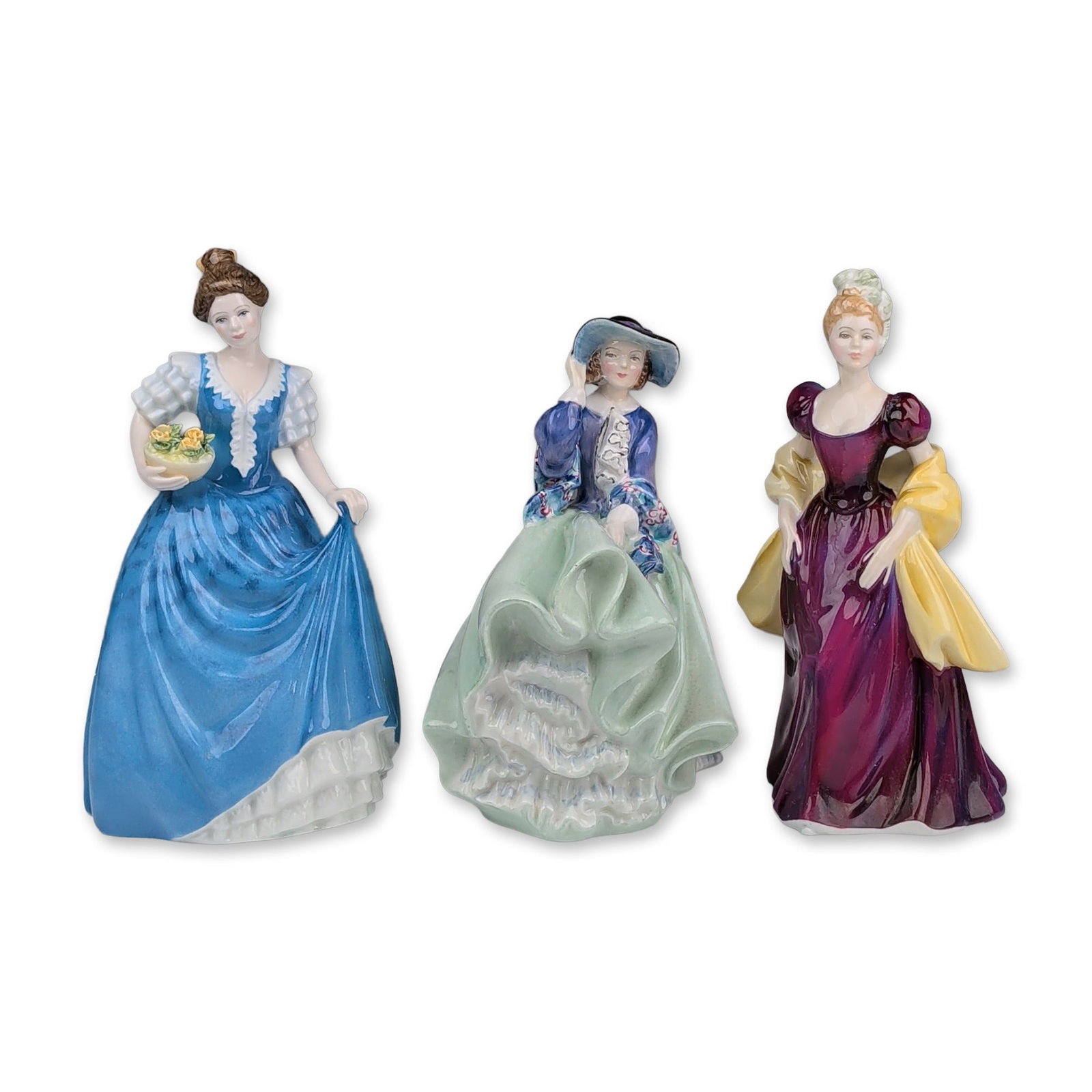 Three Royal Doulton Figurines, Loretta HN2337, Top o' the Hill HN1833 & Helen HN3601: Three Royal Doulton figurines each depicting a lady in period costume with hand-painted decoration. Top O' The Hill (HN 1833), depicts a woman in a wind-swept pose wearing a pale green ruffled skirt a