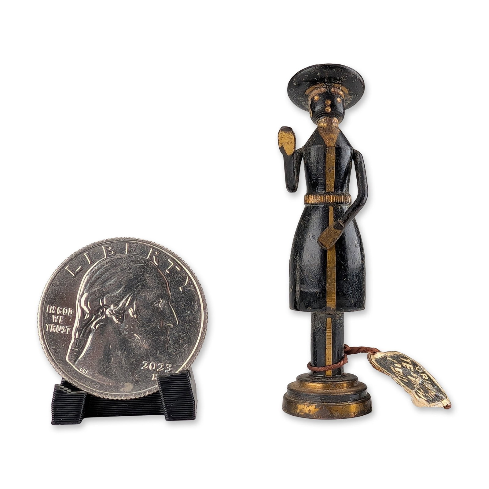 Mid-Century Hans Teppich Miniature Brass Figurine: Mid-century brass figurine depicting a figure in traditional attire including a long coat and wide-brimmed hat. Finished in black with gilt highlights. The underside of the base retains a rectangular 