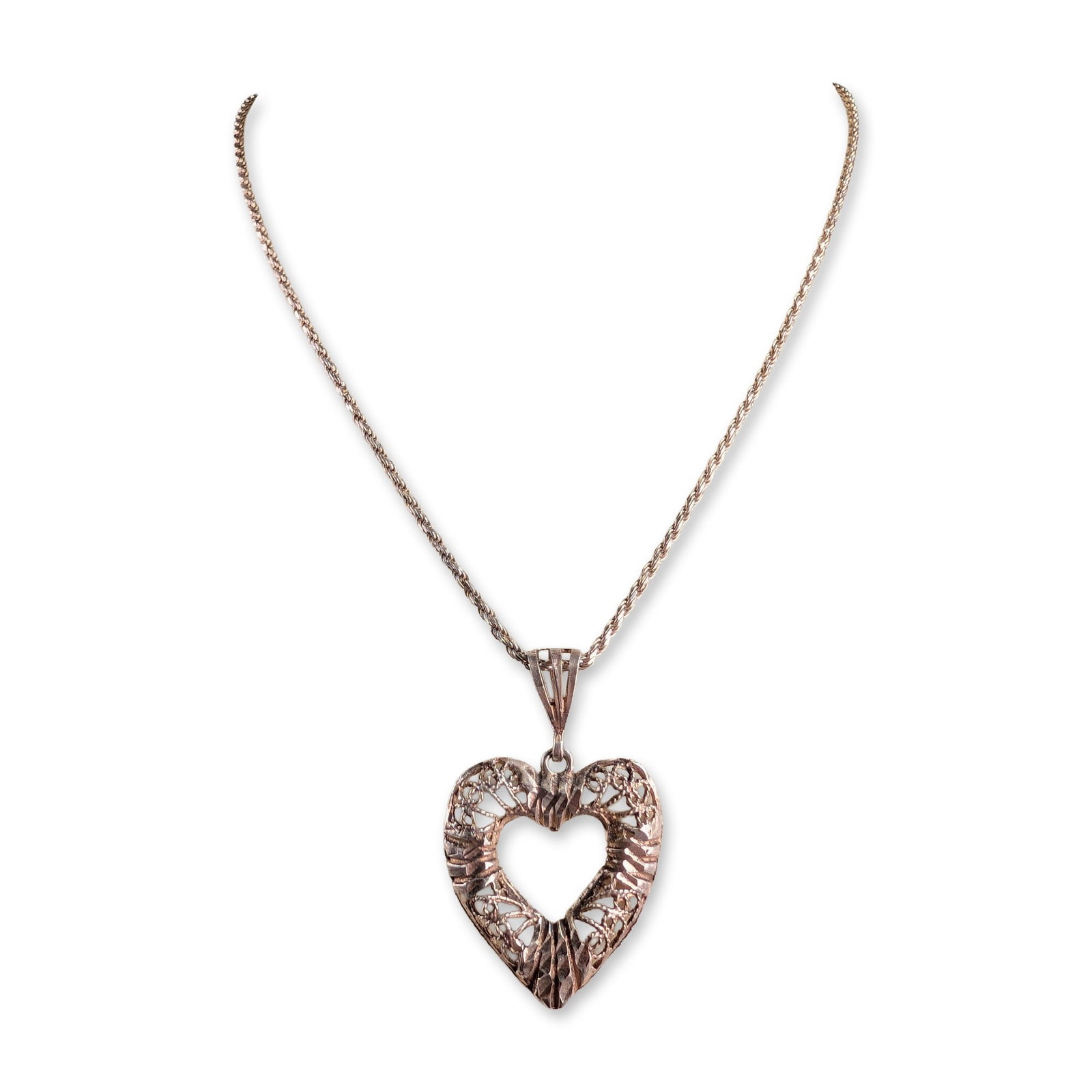 Italian Sterling Silver Filigree Heart Pendant Necklace: Italian sterling silver pendant necklace featuring a large openwork heart-shaped pendant with a rose gold-tone finish. The pendant design includes intricate filigree scrollwork within the frame, accen