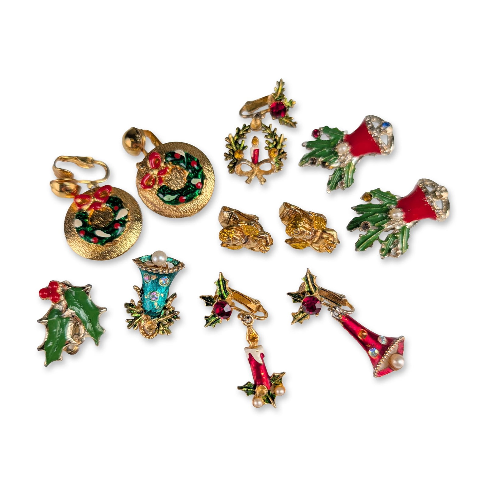 Collection of Eleven Vintage Christmas Costume Clip-On Earrings: Mid-to-late 20th-century. Group of eleven Christmas-themed costume clip-on earrings in gold-tone and silver-tone base metals, comprising 3 pairs and 5 single earrings. The lot features various holiday