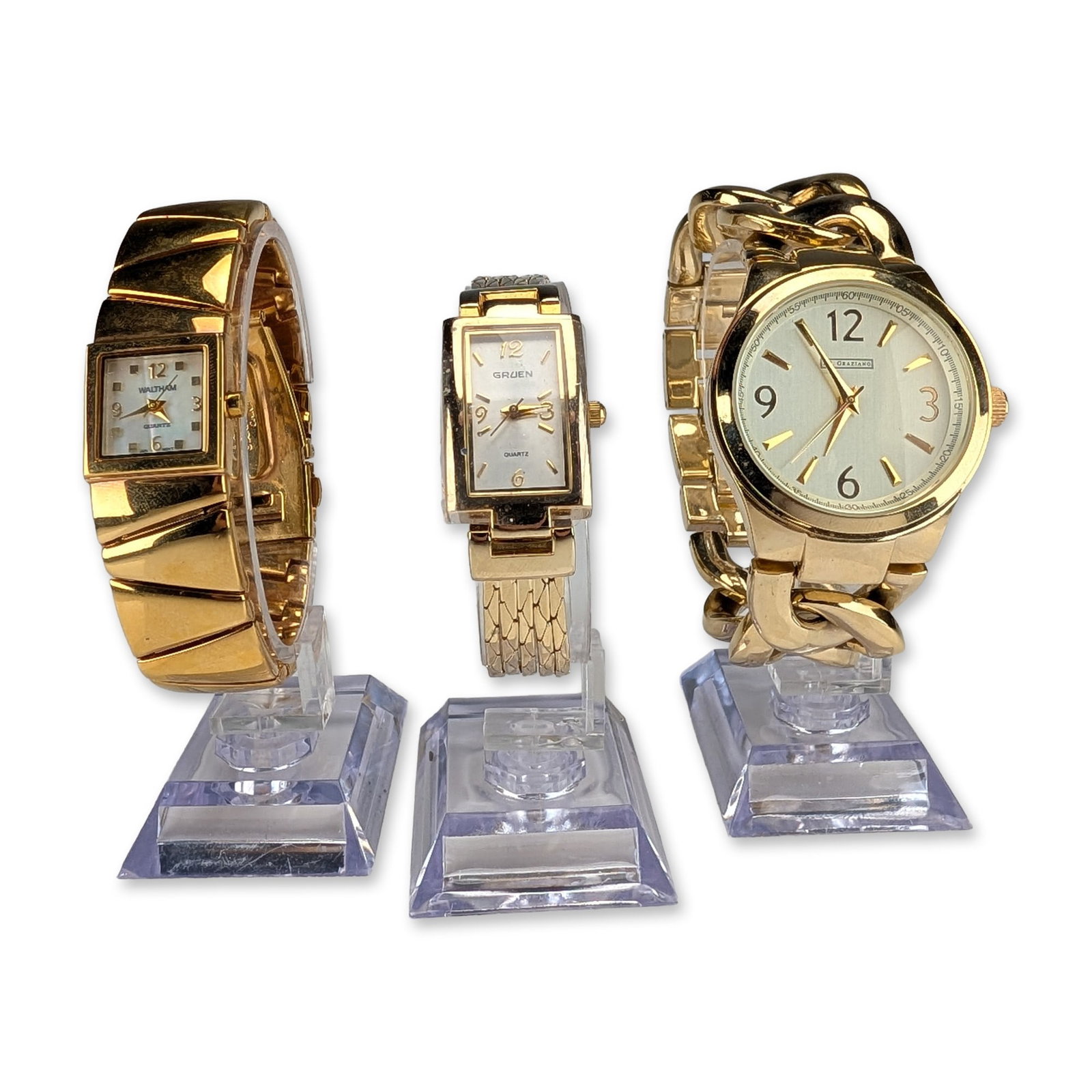 3pc Ladies Gold Tone Fashion Wristwatches: Trio of contemporary ladies gold tone fashion wristwatches featuring examples by Waltham, R.J. Graziano, and Gruen. The Waltham watch features a square off-white dial with gold tone baton markers and 