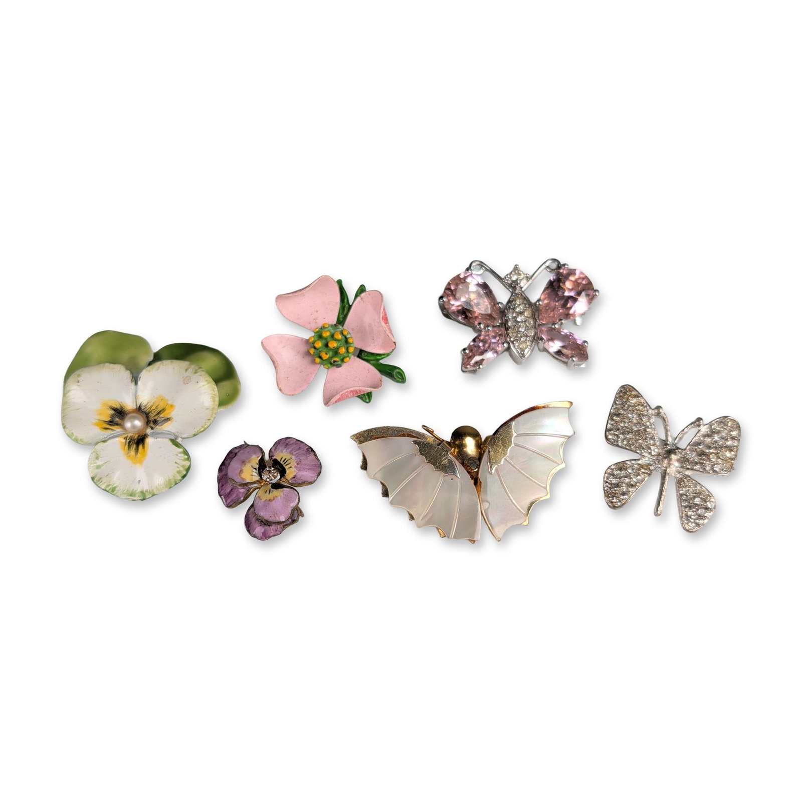 6pc Floral and Buttery Enamel Brooches: Assortment of vintage costume jewelry brooches in silver-tone and gold-tone base metals, featuring butterfly and floral motifs. Features a butterfly brooch set with pink teardrop faceted rhinestones a