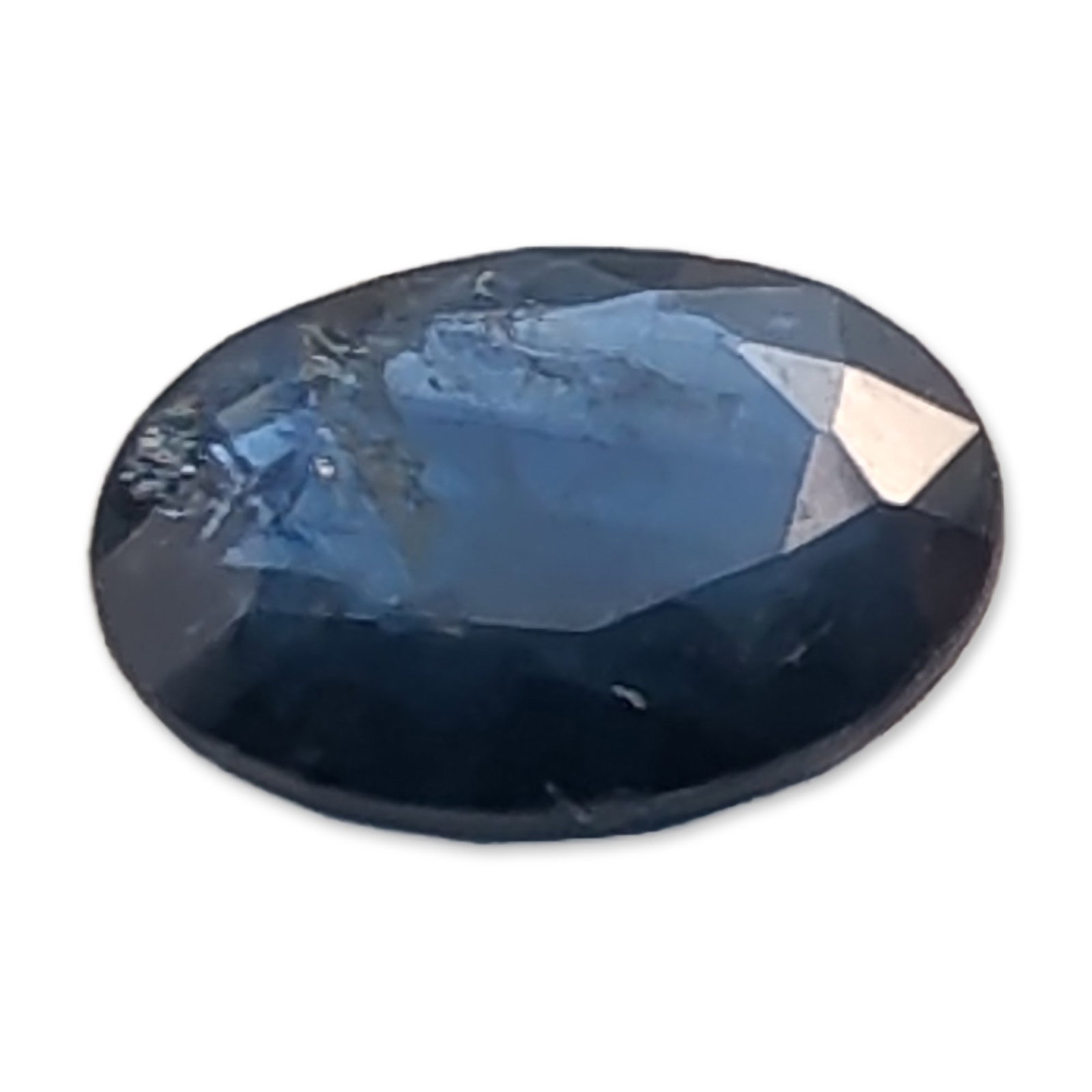 Loose Oval Faceted Navy Blue Sapphire Gemstone: Loose faceted Sapphire gemstone in a deep navy blue color. The stone is worked into an oval faceted cut.Approximate length: 9.1 mmWeight: approximately 2.2 carats. Dimensions: 9.1 mmL x 9.1mm