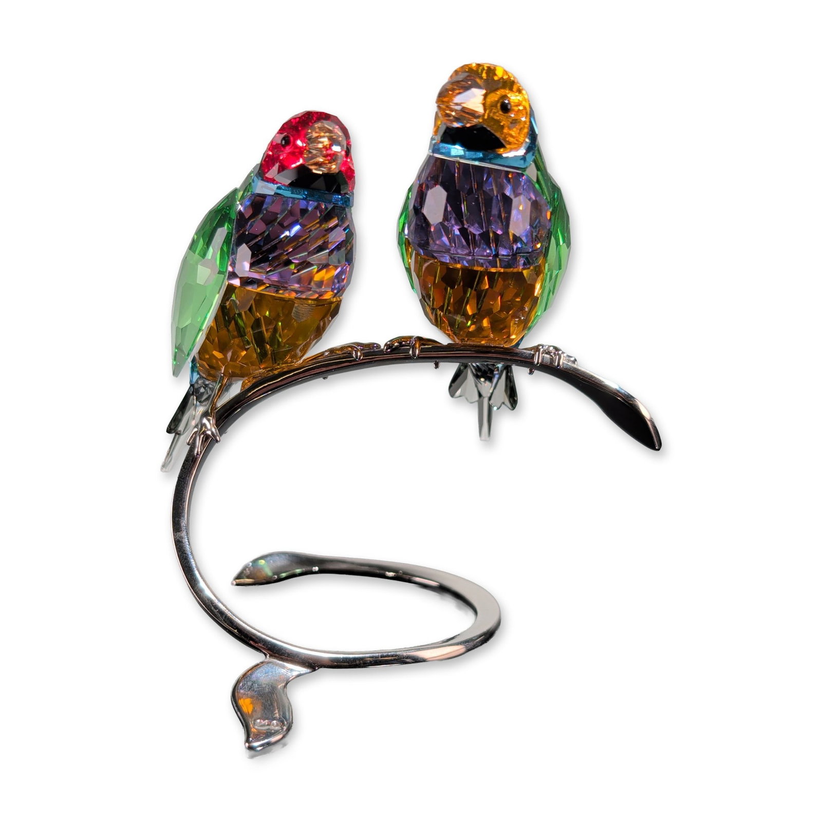 Swarovski Crystal Gouldian Finches Figurine: Swarovski Gouldian Finches figurine in faceted lead crystal and silver-toned metal, featuring two birds with multi-colored plumage in peridot green, sapphire blue, amethyst purple, and amber crystal. 