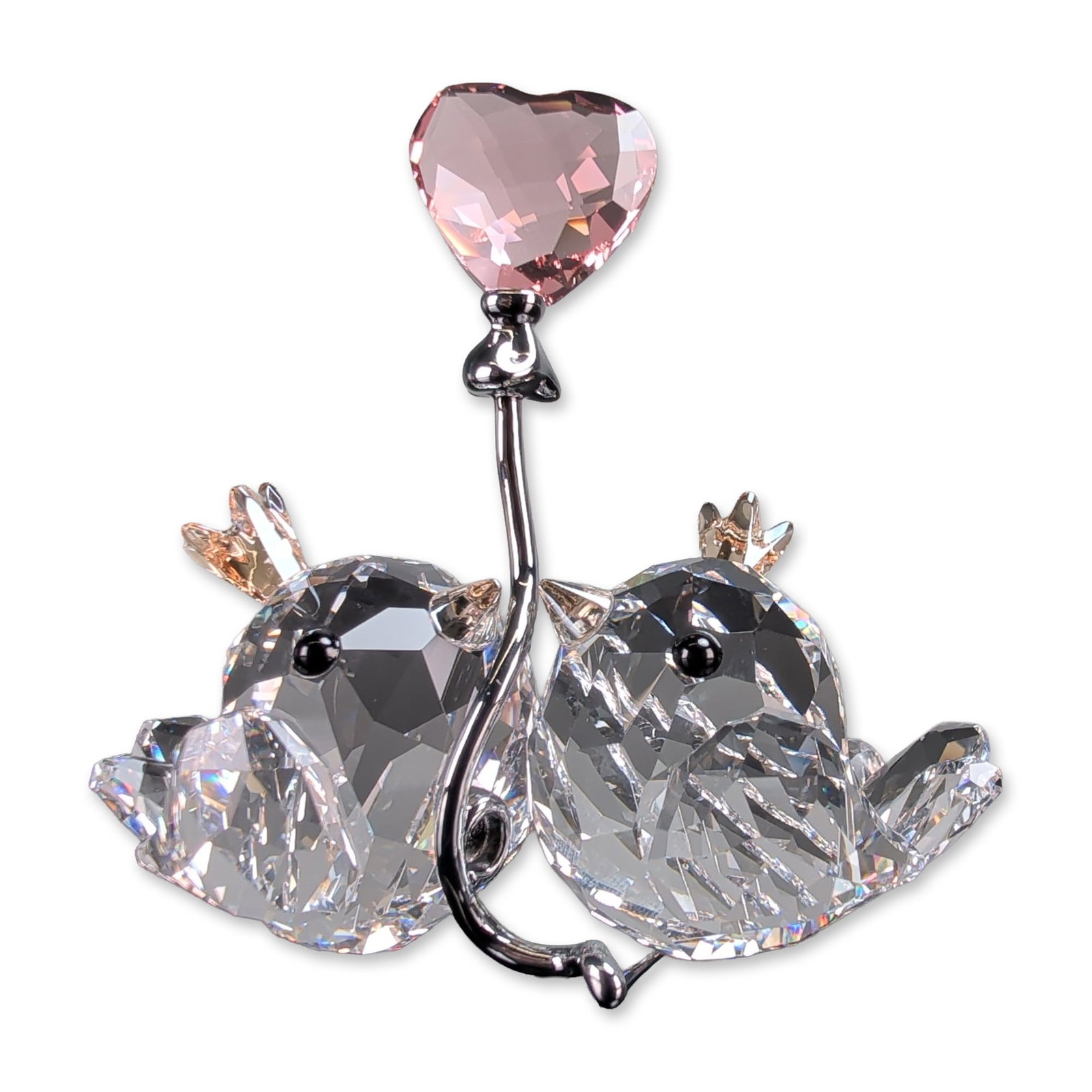 Swarovski Crystal Love Birds Pink Heart Figurine: Swarovski figurine in faceted lead crystal and silver-tone metal, titled Love Birds from the With Love collection. The piece depicts a pair of birds perched on a curved branch, with one bird holding a