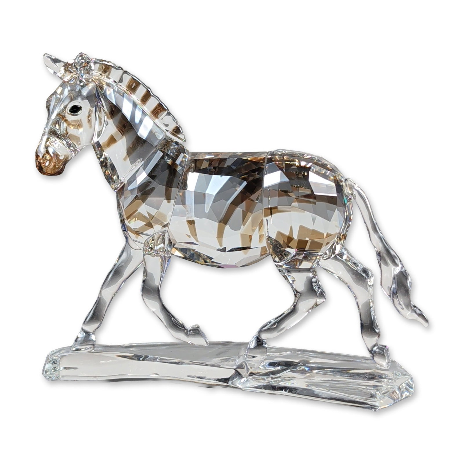 Swarovski Crystal Rare Encounters Figurine, Zebra: Swarovski crystal zebra figurine designed by Elisabeth Adamer for the Rare Encounters collection. The piece is constructed from clear faceted lead crystal featuring integrated Marron smoky-brown facet