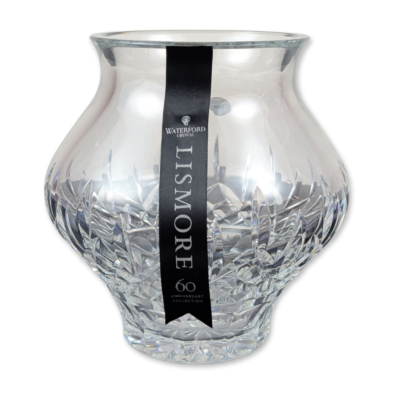 Waterford Lismore 60th Anniversary Signed Crystal Vase: Waterford lead crystal vase in the Lismore pattern, part of the 60th Anniversary Collection. The bulbous vessel features hand-cut diamond patterns and vertical wedge cuts below a flared rim. The base 