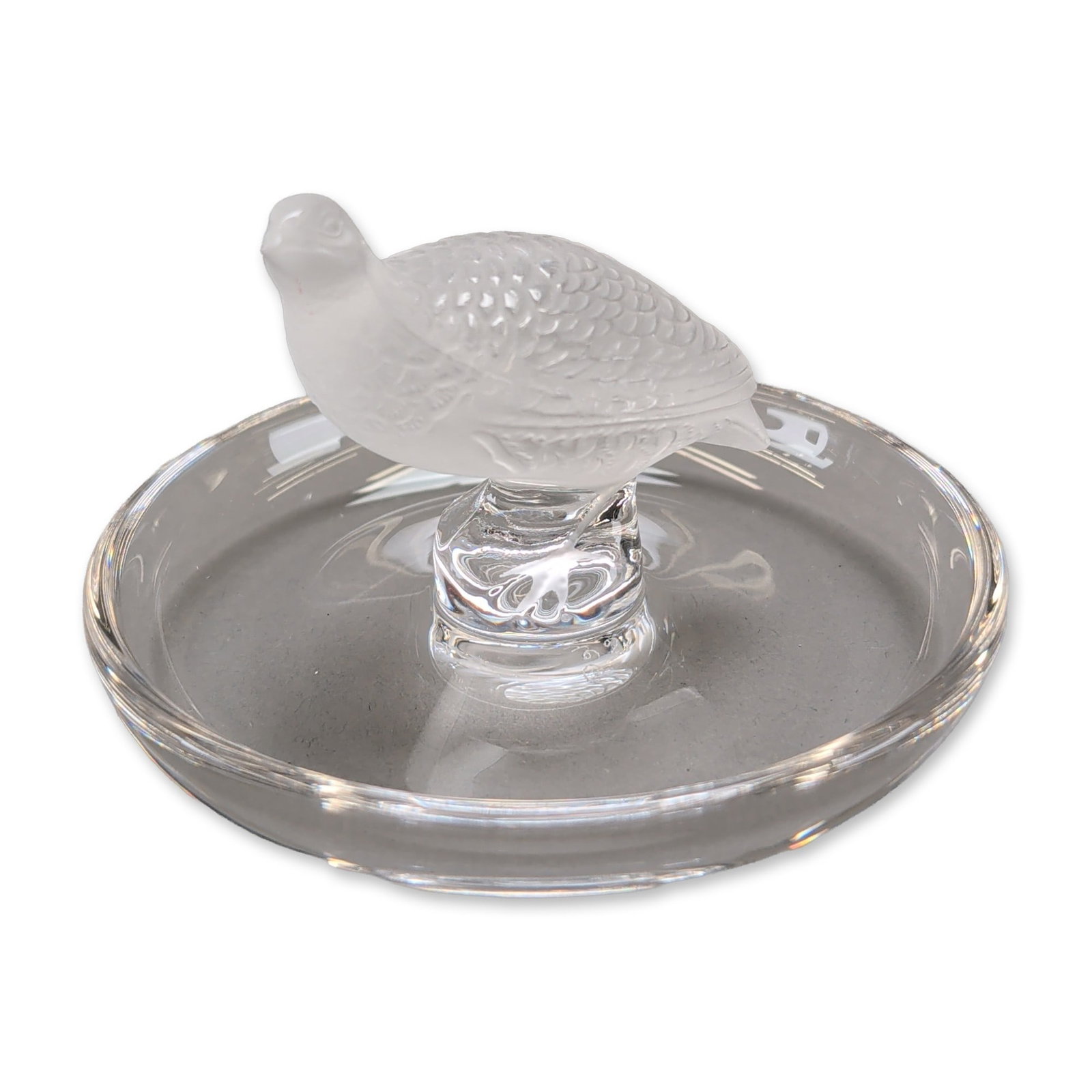 Lalique Crystal Partridge Pin Tray: Lalique, France. A crystal pin tray featuring a frosted Partridge figurine mounted to the center of a clear circular dish. The bird is depicted with detailed molded feathers and a satin finish. The cl