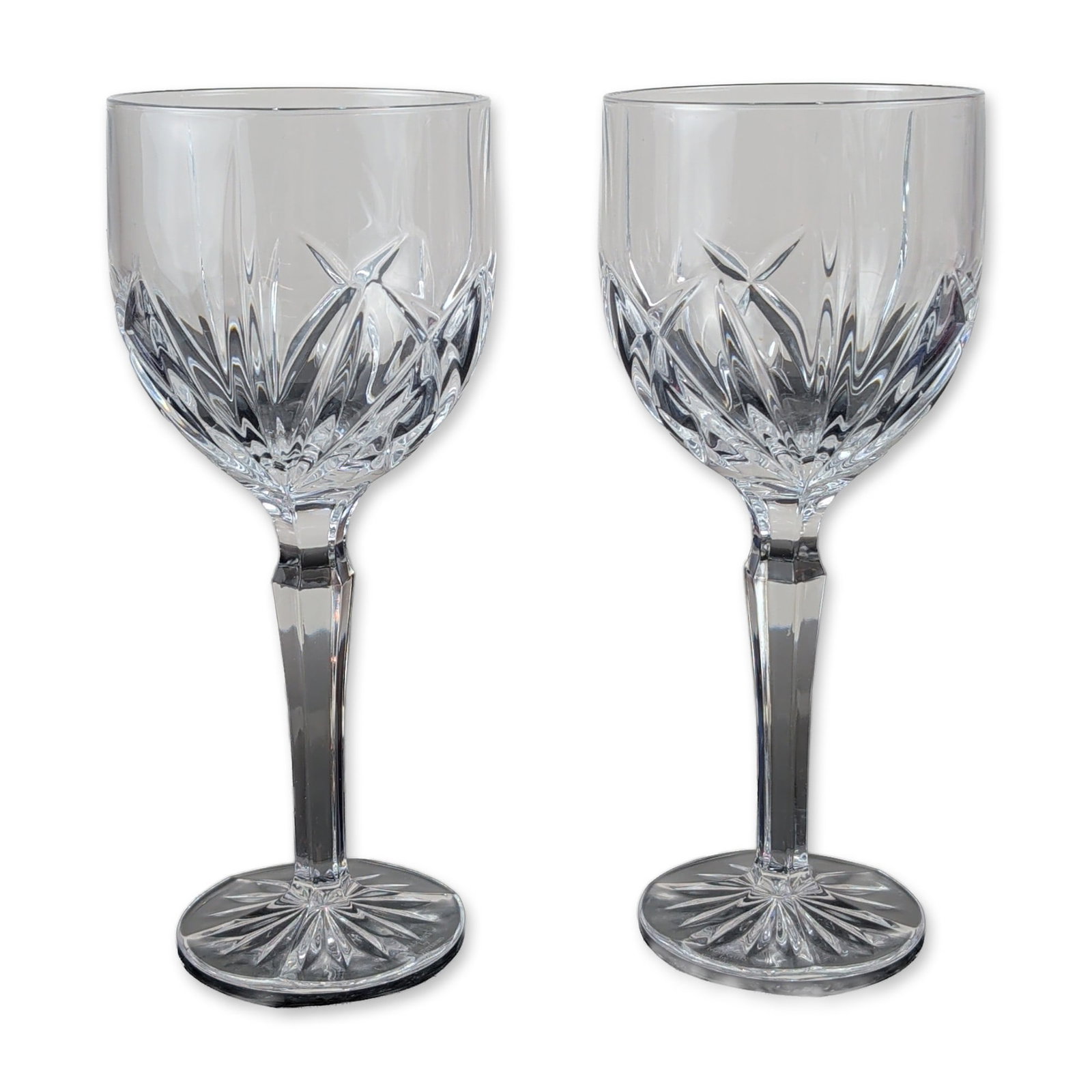 2pc Marquis by Waterford Crystal Water Goblets, Brookside: Marquis by Waterford crystal goblets in the Brookside pattern, featuring deep-cut vertical wedge cuts above a band of criss-cross diamond cutting. Each glass is constructed with a multi-faceted hexago