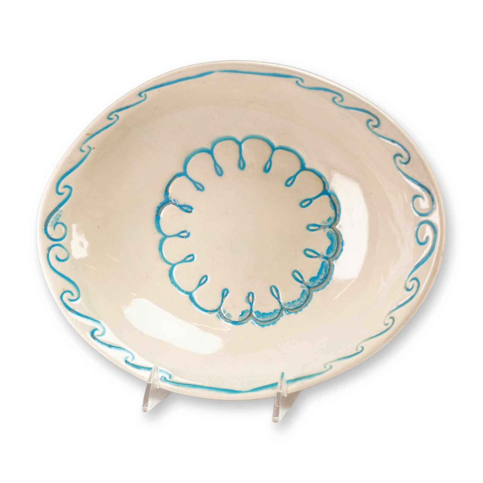 McCoy Decorative White Floral Bowl: McCoy decorative white floral bowl. This glazed ceramic shallow bowl features a cream ground decorated with turquoise blue hand-painted motifs, including a wavy rim border and a central looped circula