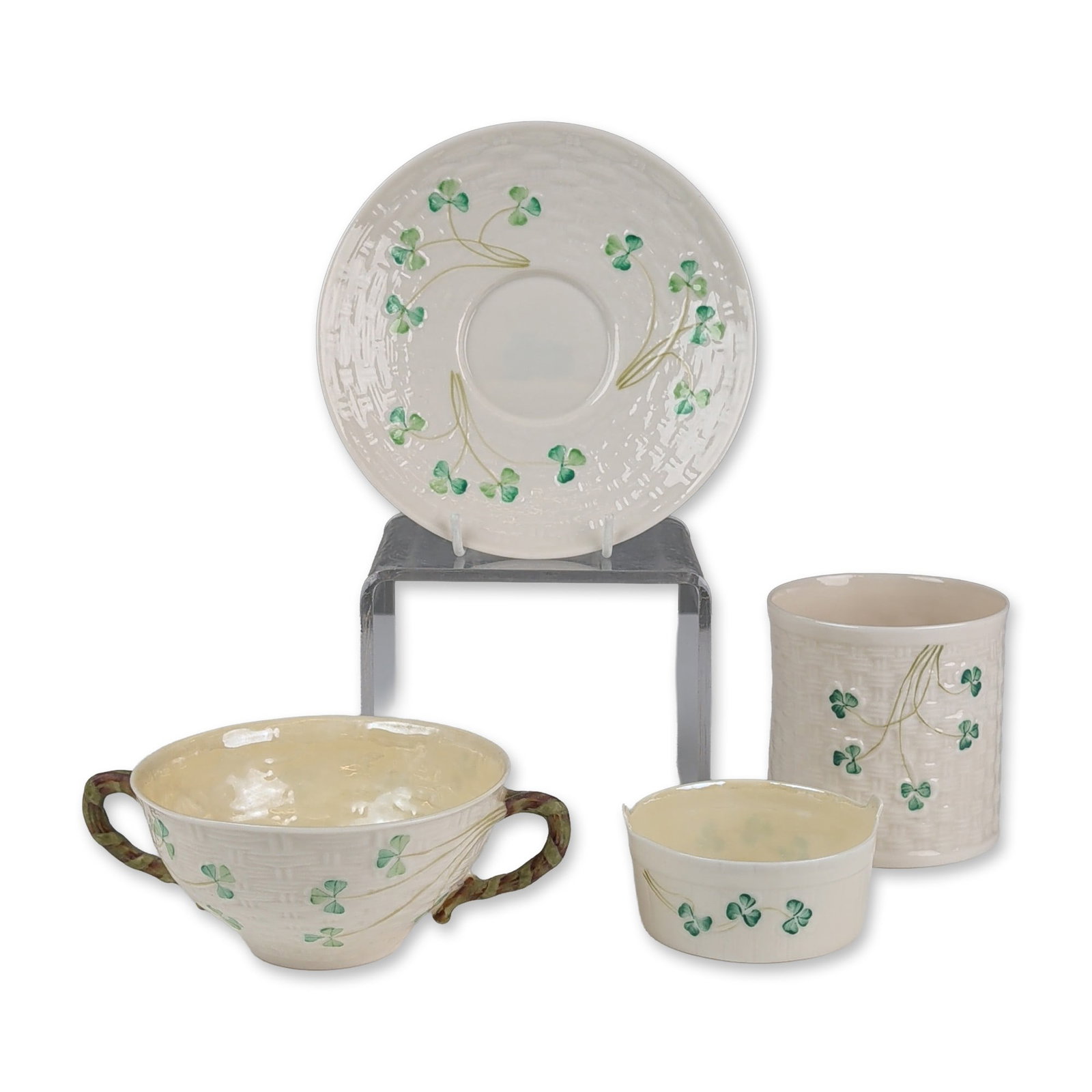 4pc Belleek Parian Porcelain Shamrock Tableware - Cup, Soup Cup, Basket and Plate: Belleek Pottery (Ireland), late 20th century. Collection of Parian porcelain in the Shamrock pattern, featuring relief-molded basketweave texture and hand-painted green shamrocks on brown stems. The g