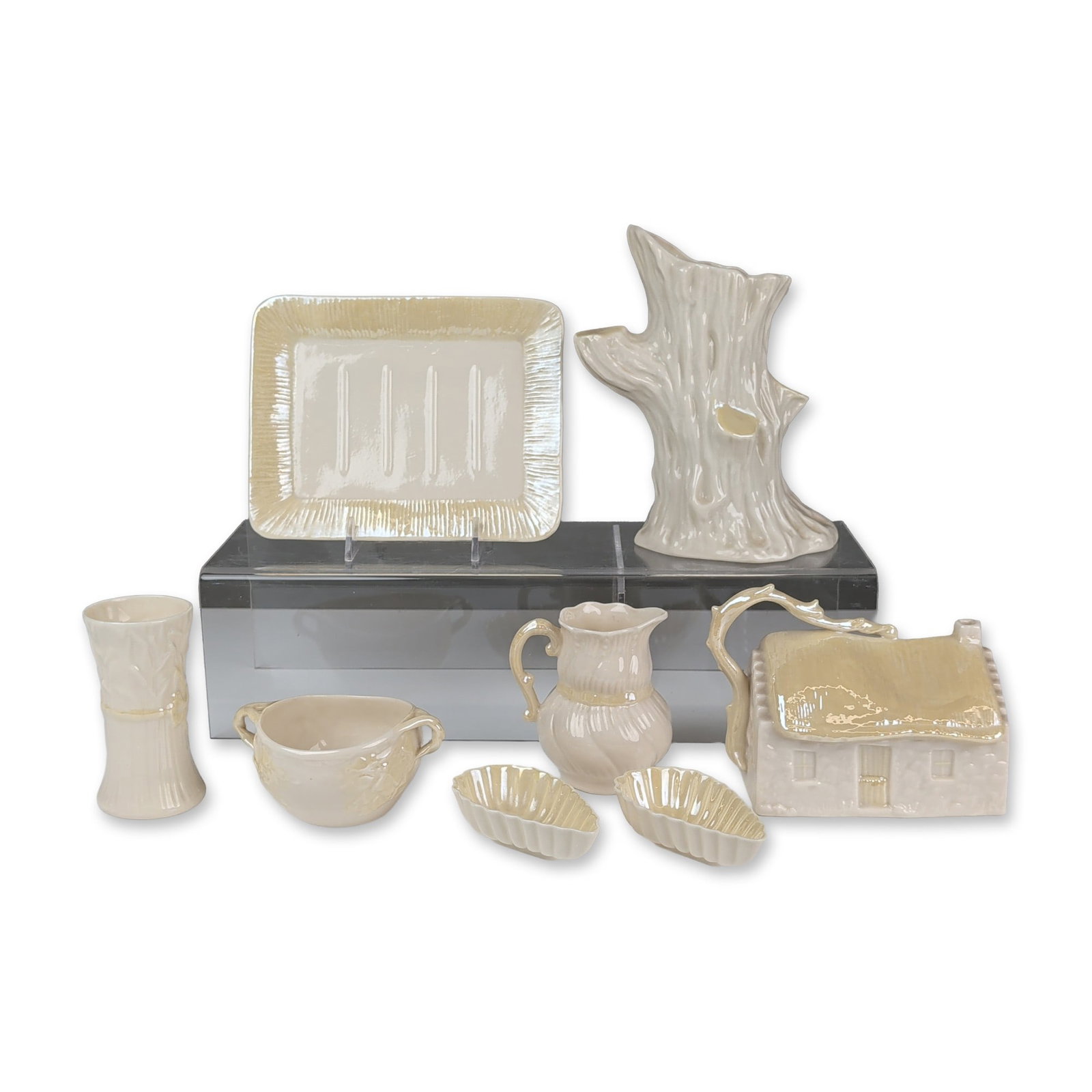 Collection of Eight Belleek Ireland Parian Porcelain Vases and Tableware: Eight-piece collection of Irish Parian porcelain, each featuring a cream-colored body with a pearlescent luster glaze finish. The group includes a large tree trunk form vase with relief-molded branche