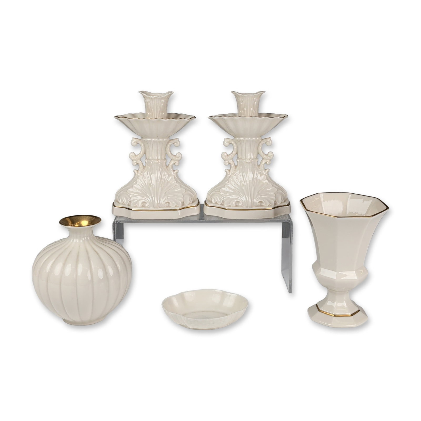 Collection of Five Lenox Cream Colored Porcelain Vases, Candle Holders and Nut Dish: Lenox cream-colored porcelain giftware collection featuring pieces from the Aquarius pattern, hand-decorated with 24-karat gold accents. The assortment includes a pair of double-scroll candlesticks wi