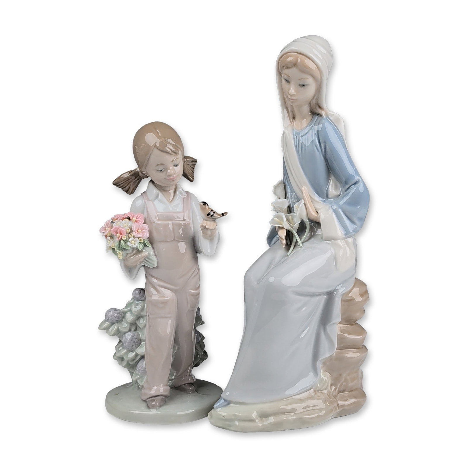 Two Lladro Glazed Porcelain Figurines, Girl with Lilies 01004972 and Spring 01005217: Two Lladro glazed porcelain figurines featuring retired models. The first is titled Sitting Girl with Lilies, designed by Vicente Martinez and issued in 1974, depicting a seated woman in a blue gown a