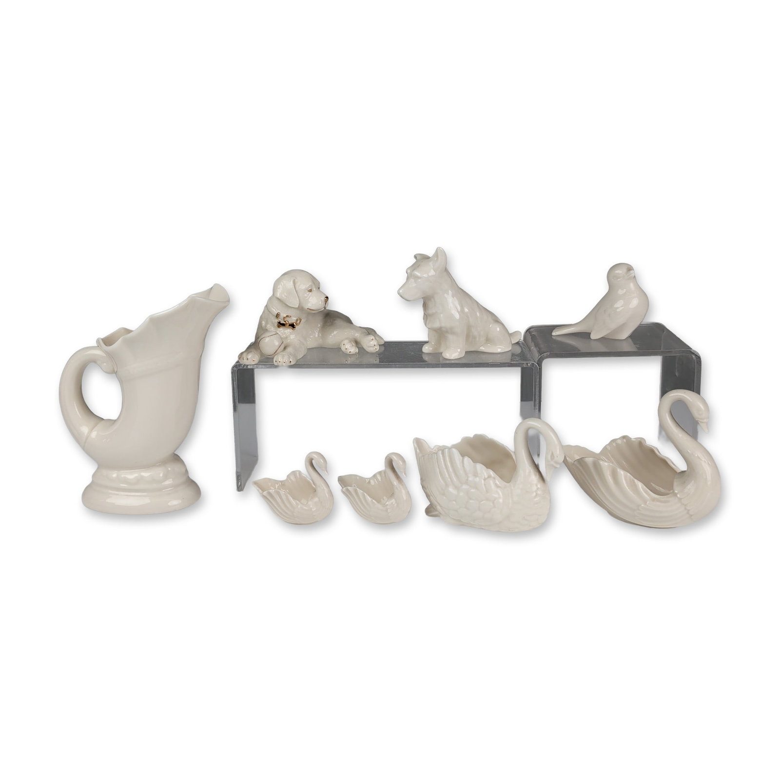 Eight Lenox Porcelain Decorative Items- Figurines, Vase and Candy Dishes: Lenox cream-colored glaze porcelain decorative collection, featuring various animal and vessel forms. The group includes a cornucopia pitcher with a scrolled handle, a recumbent dog with a gold-tone c