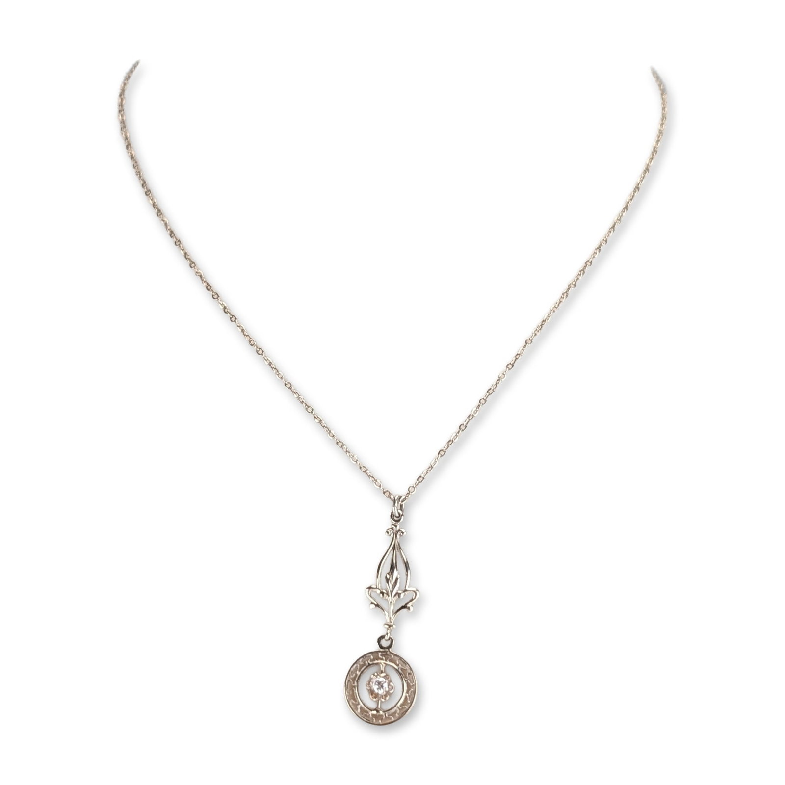 Edwardian Style 14K White Gold Filigree Pendant Necklace: Edwardian style two-part drop pendant necklace in 14K white gold. The piece features an elongated openwork filigree upper section with foliate and scroll motifs, connected to a lower circular drop wit