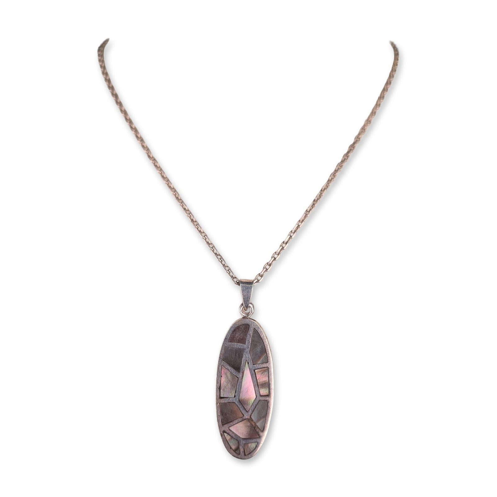Sterling Silver Mother of Pearl Mosaic Pendant Necklace: Modernist style pendant necklace in sterling silver, featuring an elongated oval pendant with a geometric shell mosaic inlay. The inlay is composed of iridescent pink and charcoal gray shell fragments