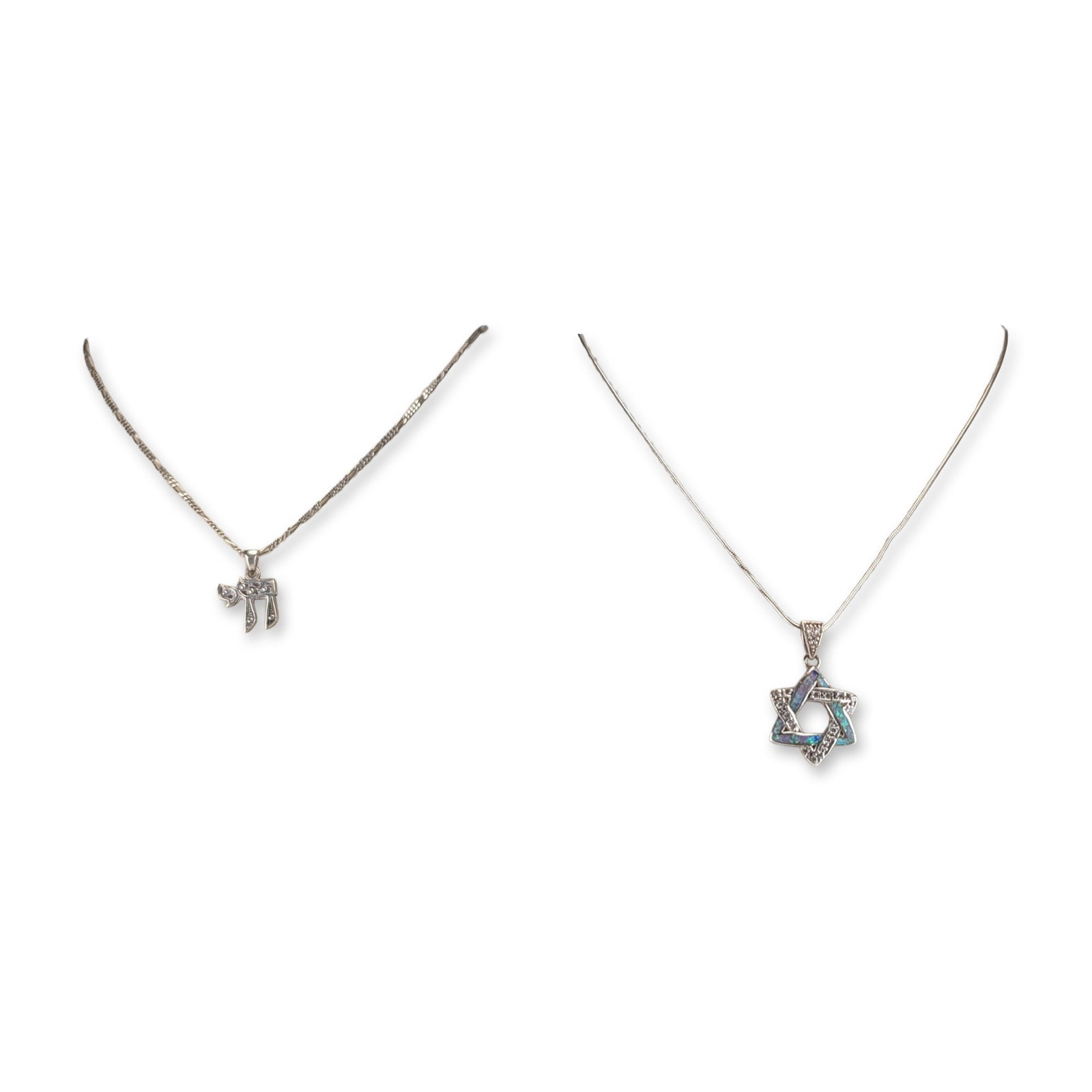 2pc Sterling Silver Judaica Pendant Necklaces: Two sterling silver necklaces featuring Judaica-themed pendants. The first piece features a Hebrew Chai symbol, suspended from a Figaro link chain. The second piece features a Star of David pendant wi