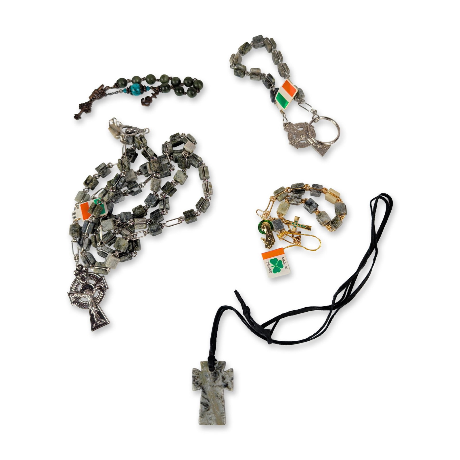 Collection of Irish Connemara Marble Jewelry: Irish. Collection of religious articles and jewelry in Connemara marble, featuring a full-sized rosary with square-cut beads and a Celtic crucifix, a rosary bracelet, a keychain, and a large carved st