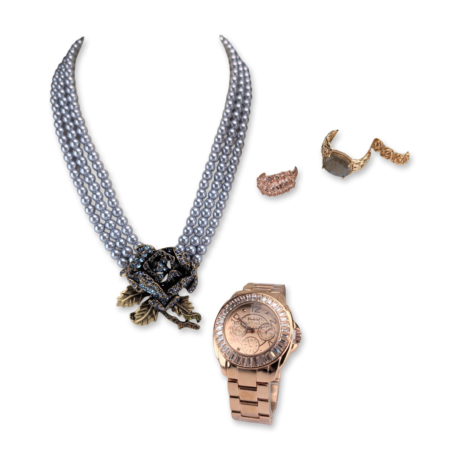 5pc Designer Jewelry Collection including Heidi Daus and Heidi Klum: Collection of jewelry and timepieces featuring a necklace, watch, and three rings. The Heidi Daus three-strand necklace is composed of grey simulated pearls with an antiqued bronze-tone floral centerp