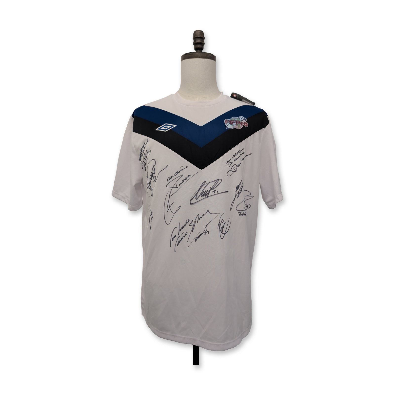 Umbro 2013 FIFPro World XI Signed Soccer Jersey: Umbro limited edition commemorative soccer jersey for the 2013 FIFPro World Team of the Year. The white short-sleeved garment features a V-neck and a distinctive blue and black chevron panel on the ri