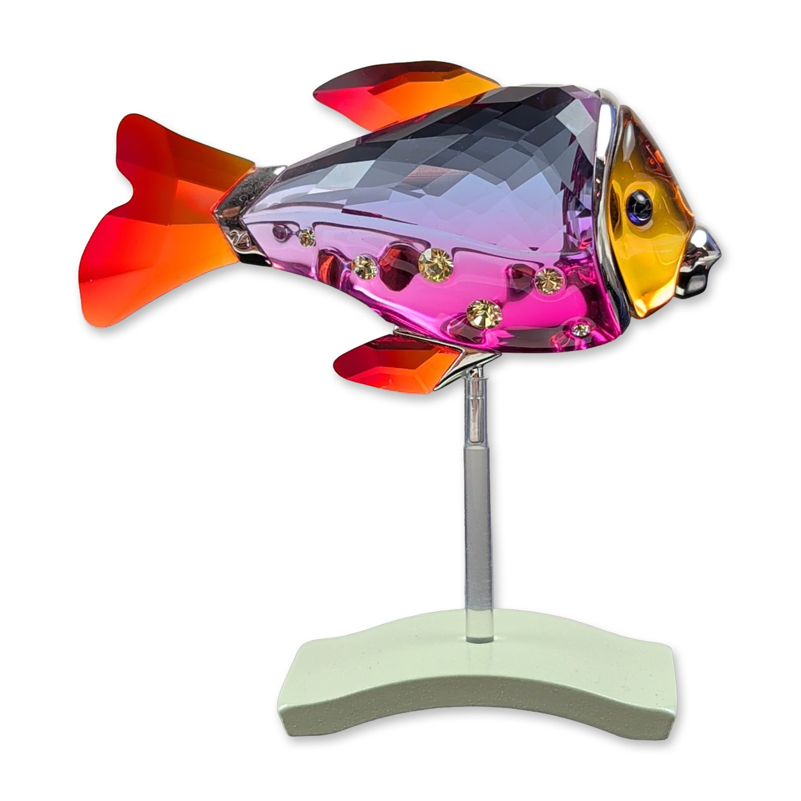 Swarovski Crystal Paradise Camaret Fish Figurine: Swarovski Crystal Paradise collection Camaret fish figurine in the Fuchsia Rain colorway. This faceted crystal figurine features a translucent amber head with a blue eye and a body with a fuchsia to l