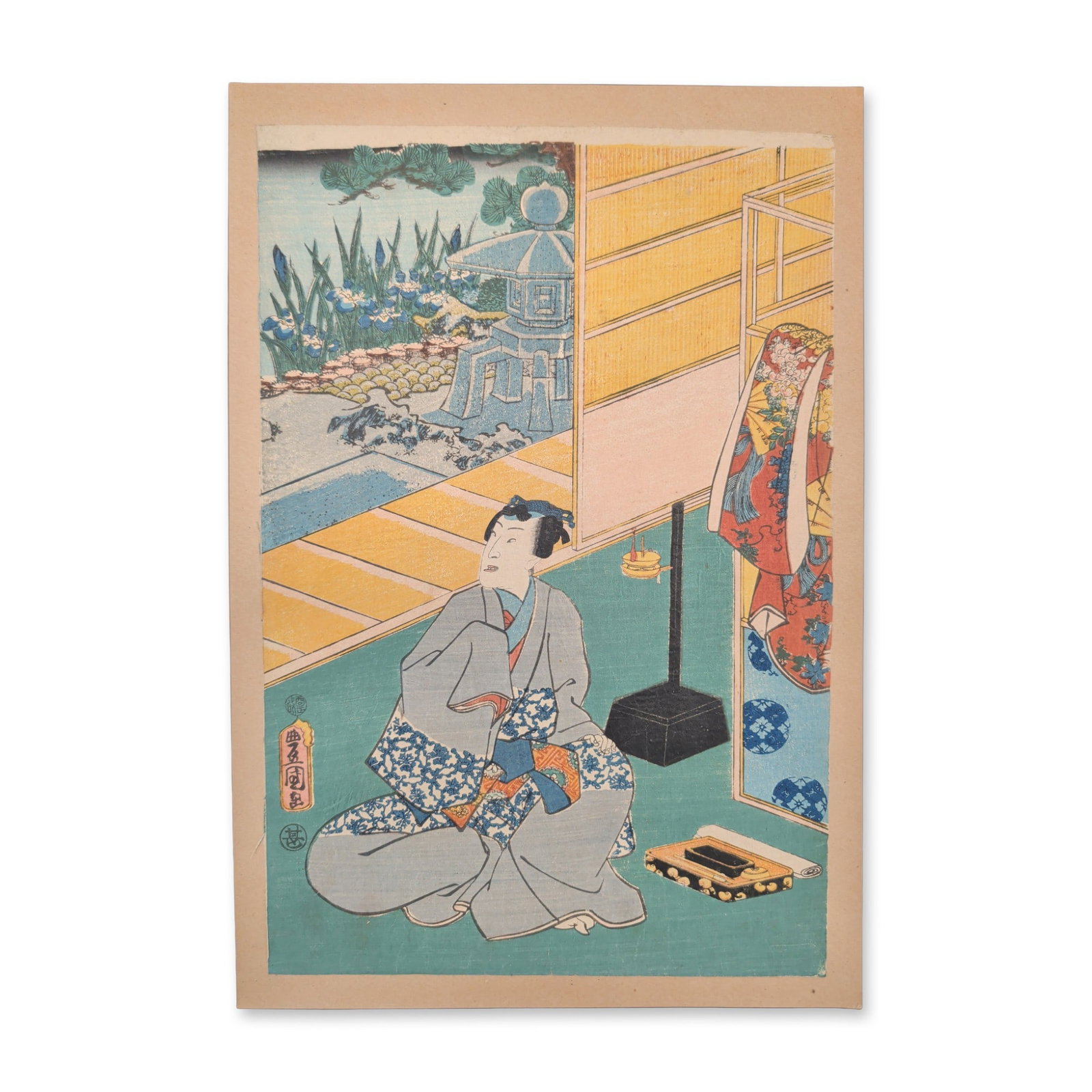 Utagawa Kunisada (Toyokuni III) (Japanese, 1786-1865) Woodcut from the series One Hundred Famous: A central male figure clad in an elegantly patterned grey kimono sits cross-legged on a traditional tatami-matted veranda, gesturing toward a lacquer writing set on the floor beside a freestanding flo