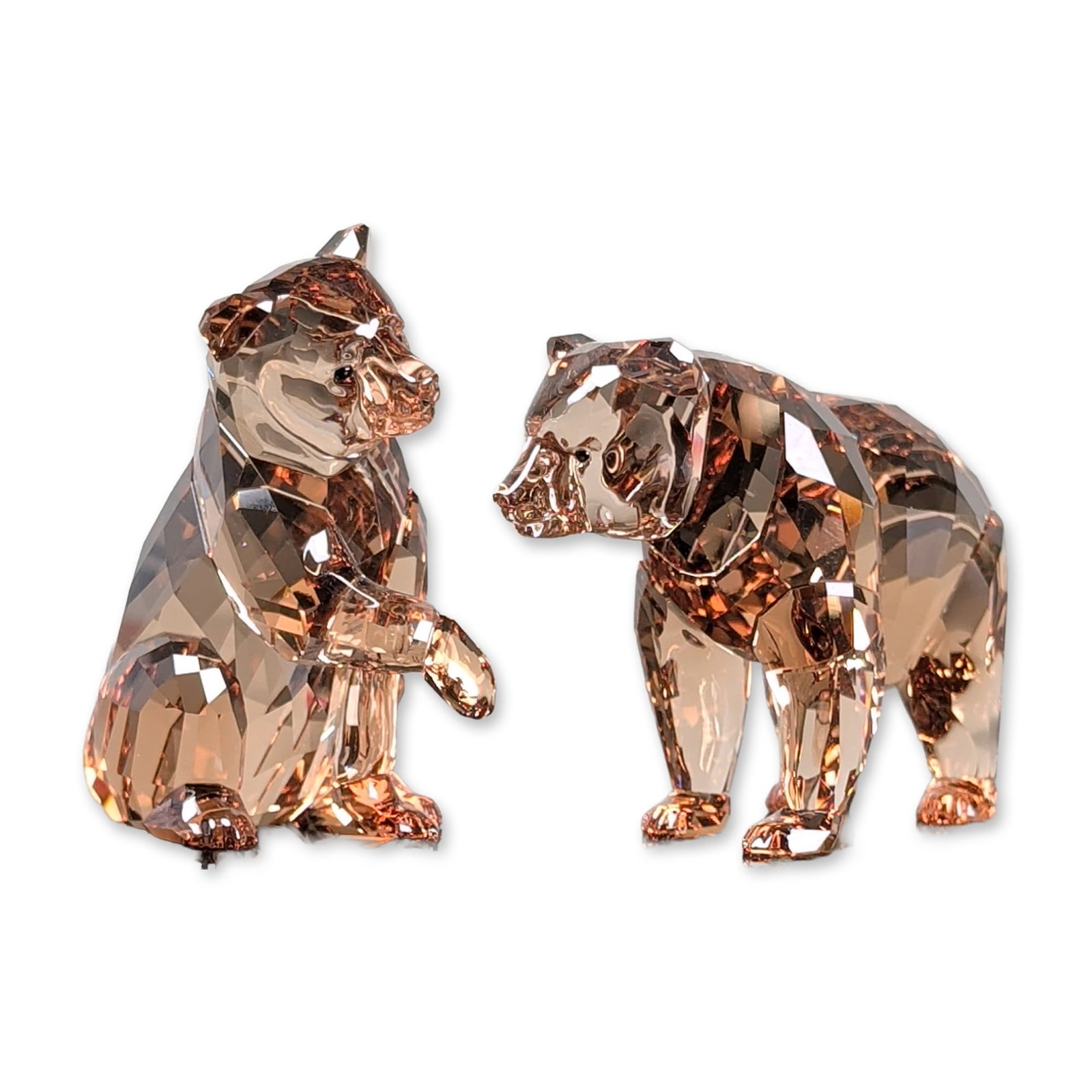 Swarovski Crystal 2017 Annual Edition Figurines, Bear Cubs: Swarovski Crystal Society (SCS) pair of faceted lead crystal bear cubs in Sunray and Smoky Quartz colorways. The figurines feature precision-cut facets throughout the bodies, depicted in naturalistic 