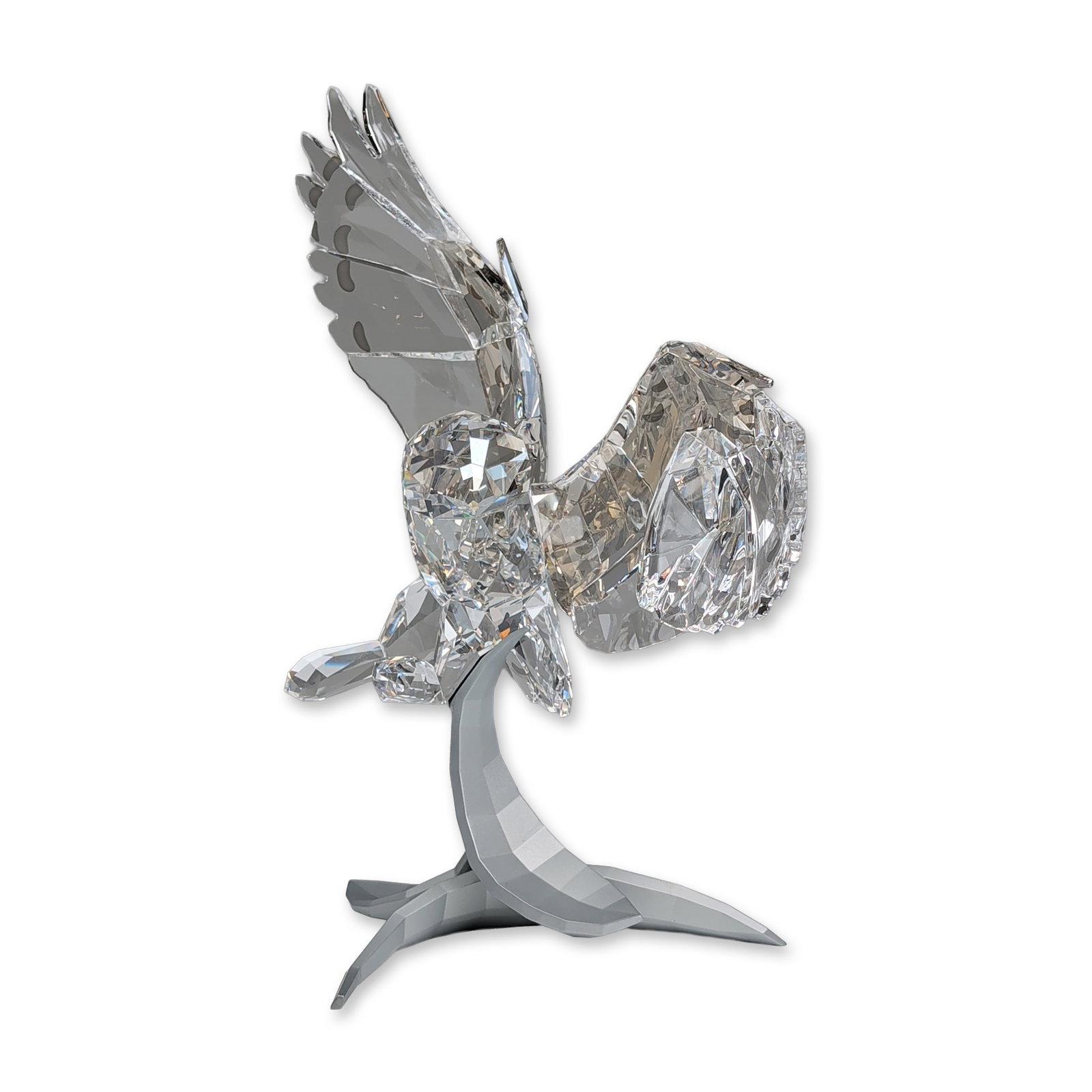 Swarovski Soulmates Crystal Figurine, Snowy Owl: Swarovski Soulmates Snowy Owl figurine in faceted Silver Shade crystal, depicting an owl in flight with extended wings and a turned head. The wings and tail feathers are detailed with frosted semi-cir