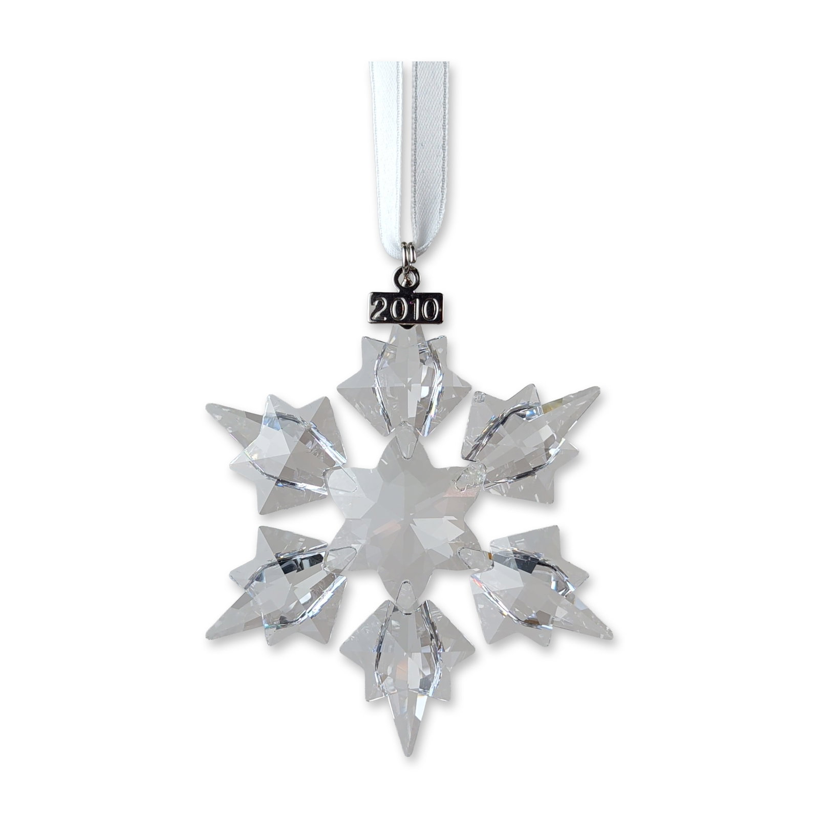 Swarovski 2010 Annual Edition Crystal Ornament: Swarovski 2010 Annual Edition snowflake ornament in clear multi-faceted lead crystal. The design features a central six-pointed star with six larger radiating faceted points. Suspended from a white sa