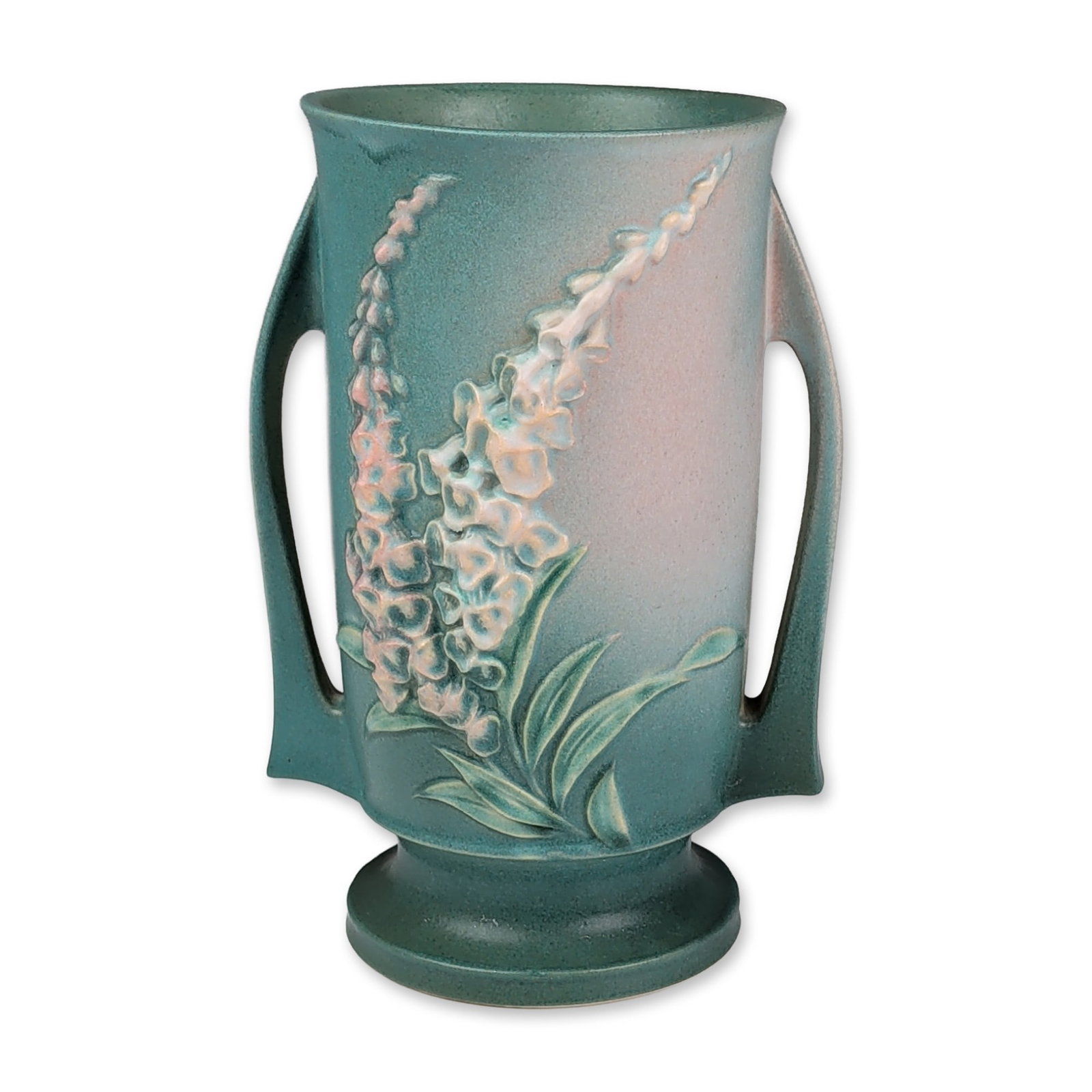 Roseville Pottery Vase, Green Foxglove: Roseville Pottery Company. Two-handled vase in earthenware art pottery, featuring the Foxglove pattern introduced in 1942. The vessel displays raised relief foxglove floral sprays in white and soft pi