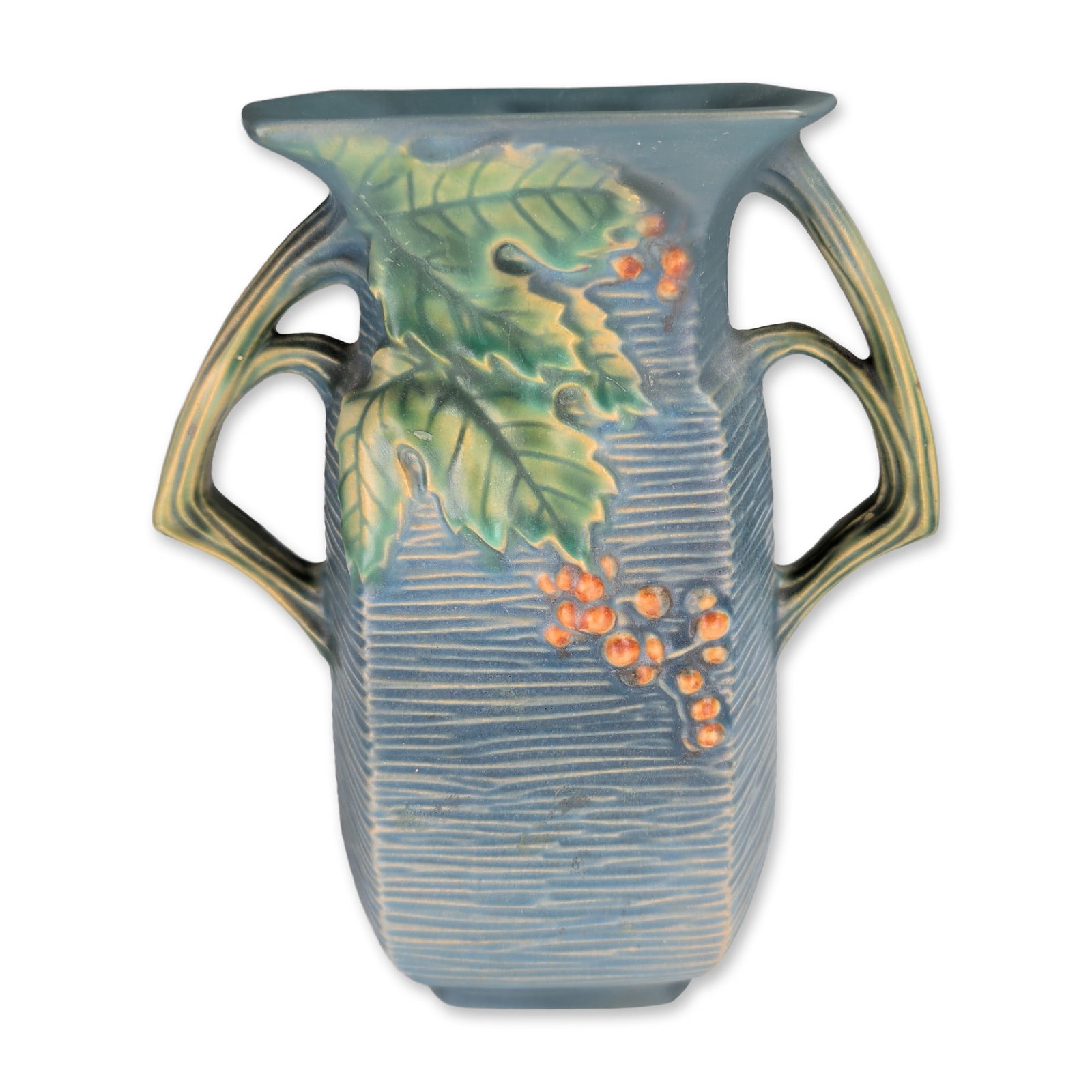 Roseville Pottery Bushberry Double-Handled Blue Ceramic Vase: Roseville Pottery, Bushberry pattern, two-handled ceramic pillow vase in blue glaze, featuring relief decoration of serrated green leaves and clusters of orange berries against a vertically ribbed, ba