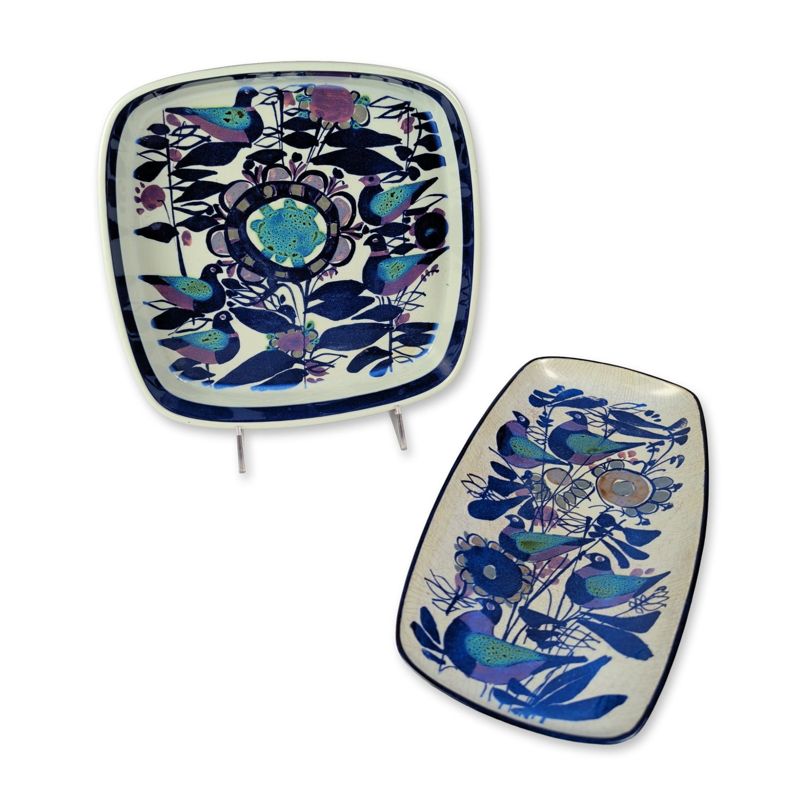 2pc Royal Copenhagen Faience Dishes: Royal Copenhagen, Denmark, pair of mid-century modern faience dishes from the Tenera series, featuring stylized bird and floral motifs. Designed by Kari Christensen under the artistic direction of Nil