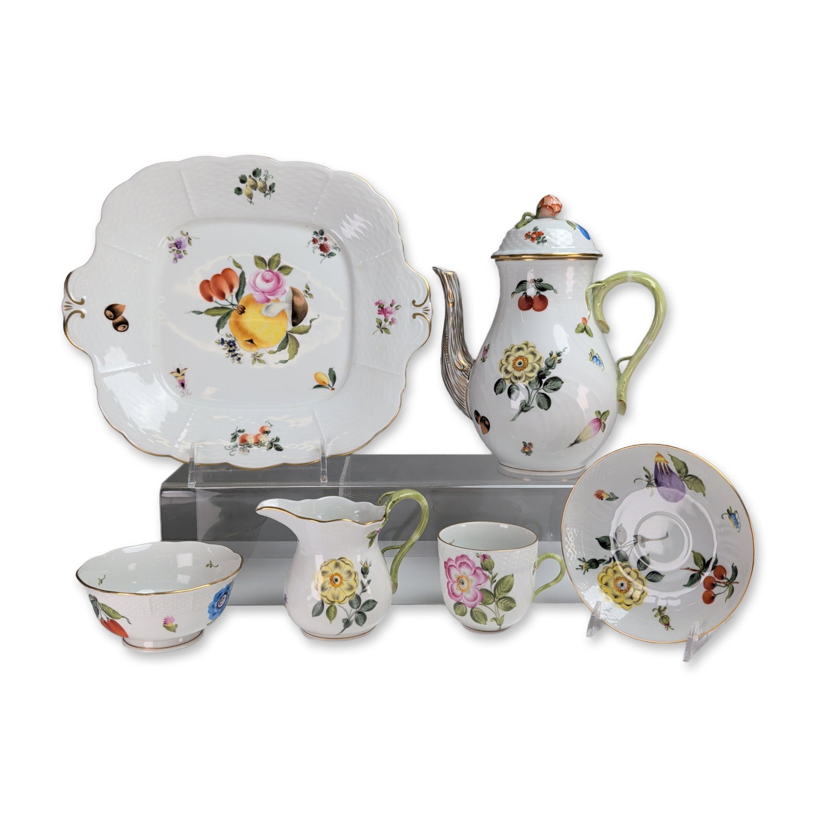 6pc Herend Fruits and Flowers Pattern Porcelain Tea Set and Square Cake Plate: Group of six hand-painted Herend porcelain tableware in the Fruits and Flowers pattern that includes a lidded coffee pot, cup and saucer, creamer pitcher, open sugar bowl, and a cake platter. Each pie