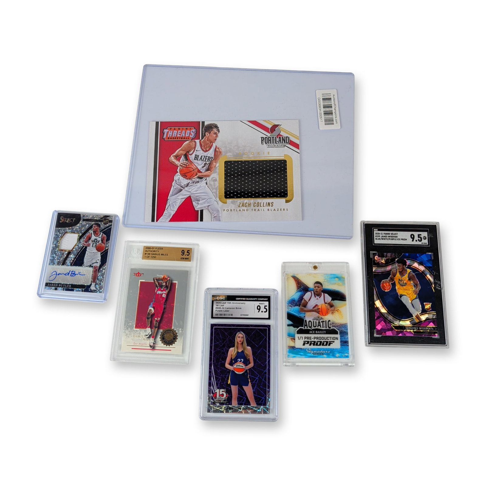 6pc Collection of Graded and Ungraded Basketball Trading Cards: Collection of six basketball trading cards featuring modern rookies and serial-numbered parallels. Includes a 2020-21 Panini Select James Wiseman Blue/White/Purple Ice Prizm rookie card, number 299,